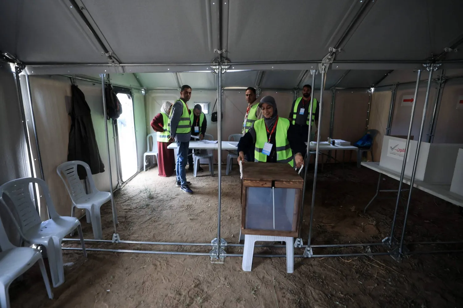 Palestinian electoral officials set up a polling station in a tent for municipal elections in Deir al-Balah, Gaza Strip, on April 25, 2026. (AFP)