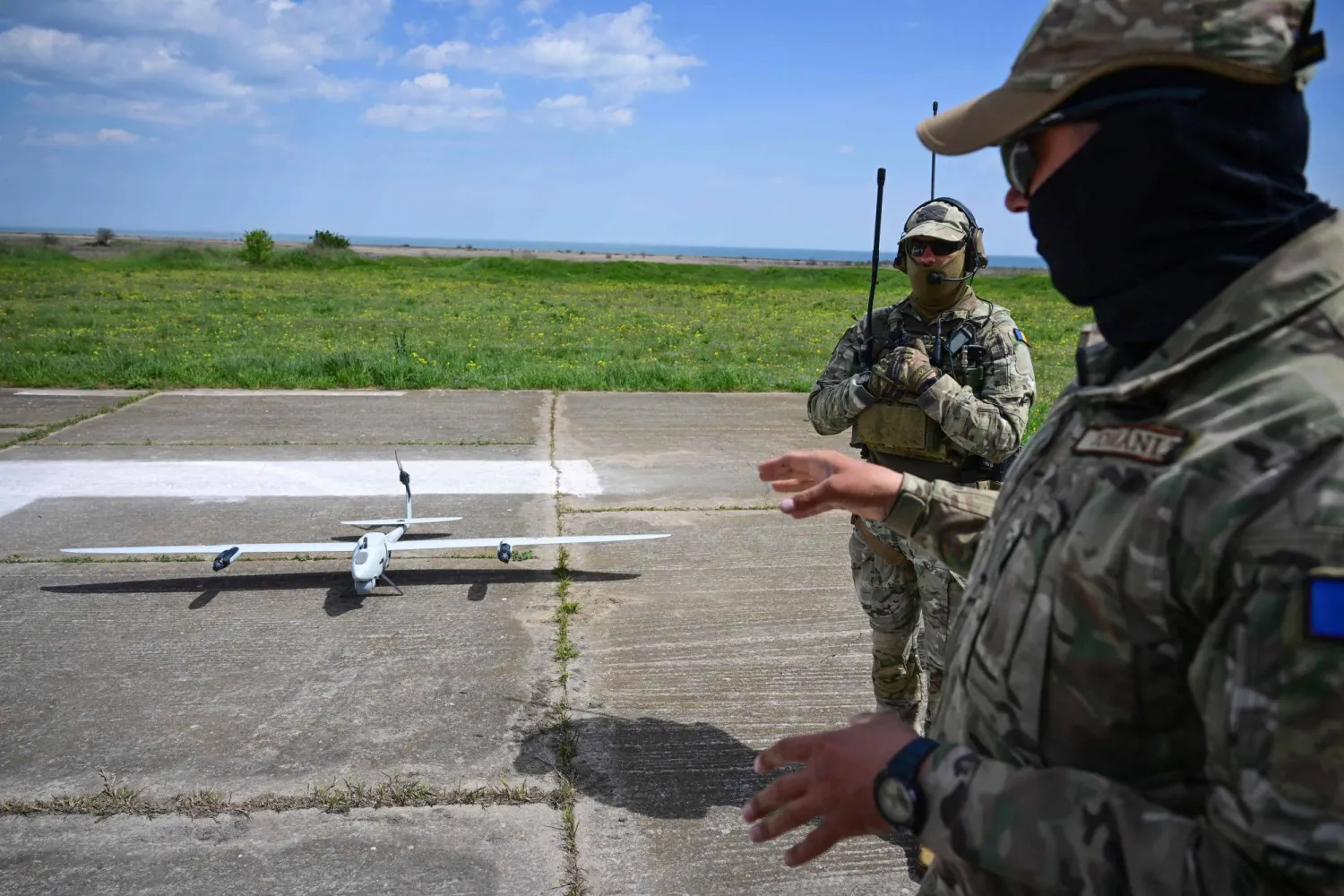 Romanian army servicemen explain the capabilities of "Vector" surveillance drone during exercise EASTERN PHOENIX 26, a training activity designed to test counter-unmanned aircraft systems (C-UAS) procedures, at Capu Midia firing range, April 24, 2026. (AFP)