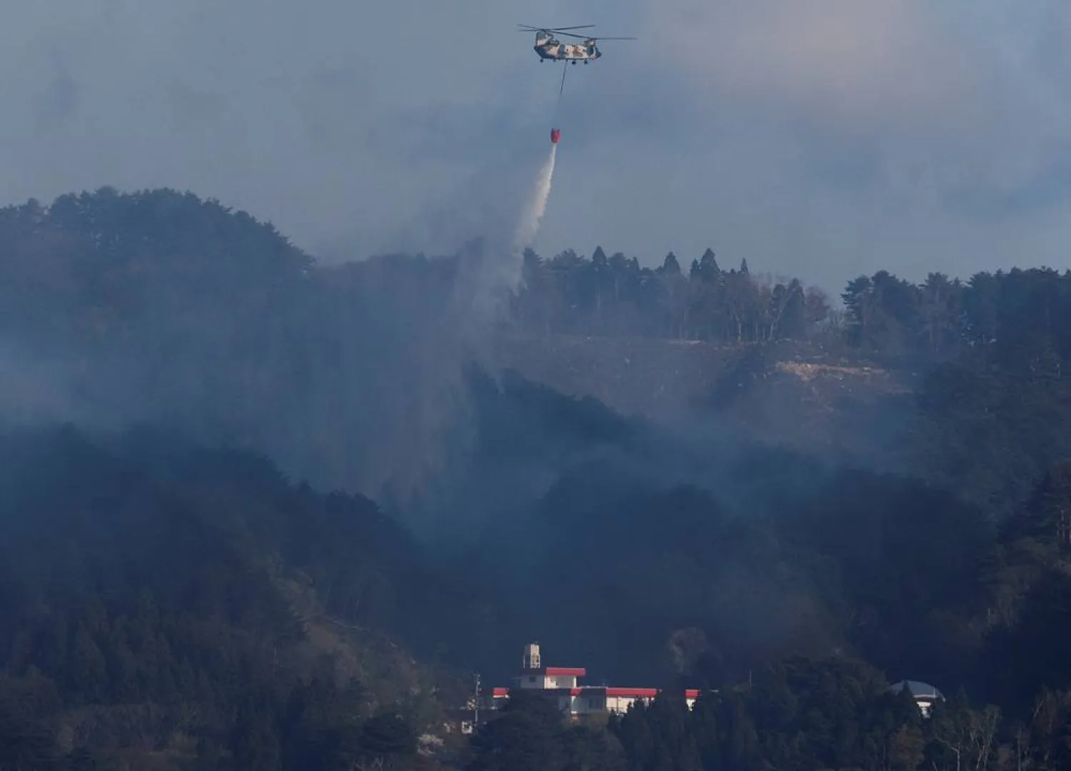  Japanese Self-Defense Forces helicopter drops water during firefighting operations, as wildfires continue in Otsuchi, Iwate Prefecture, Japan, April 25, 2026. (Reuters)