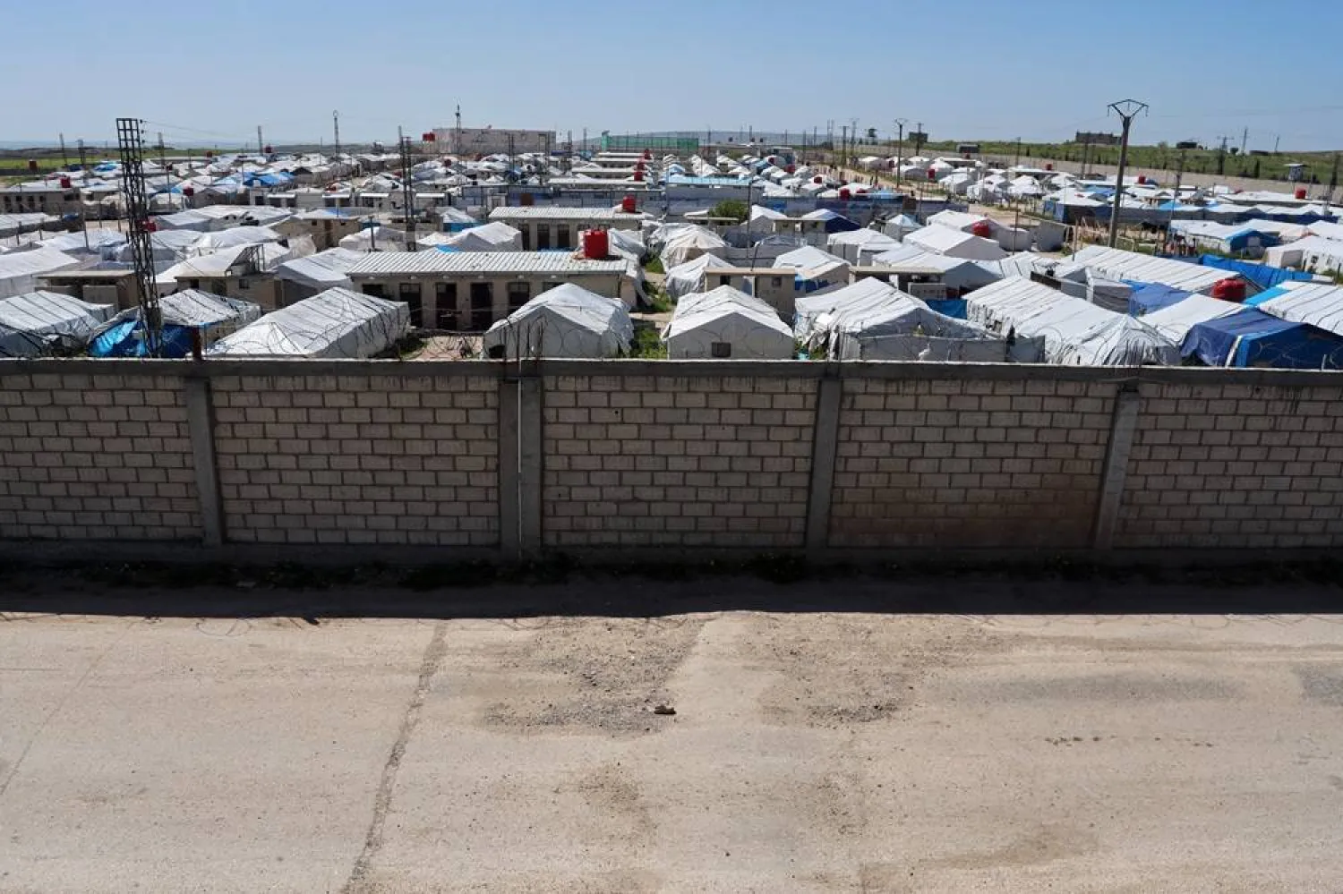 A brick wall surrounds a tent camp housing people with alleged ties to ISIS militants at Roj Camp in eastern Syria, Friday, April 24, 2026. (AP)
