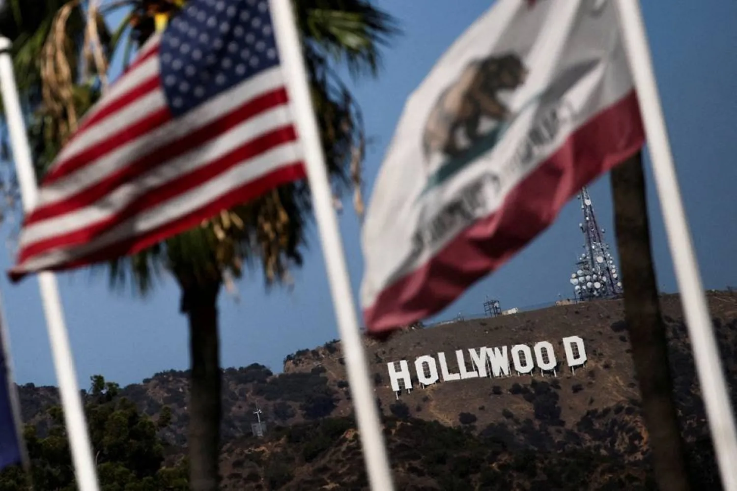 Flags flutter in front of the Hollywood Sign after US President Donald Trump ordered a 100% tariff on foreign-made films in Los Angeles, California, US, September 29, 2025. (Reuters)