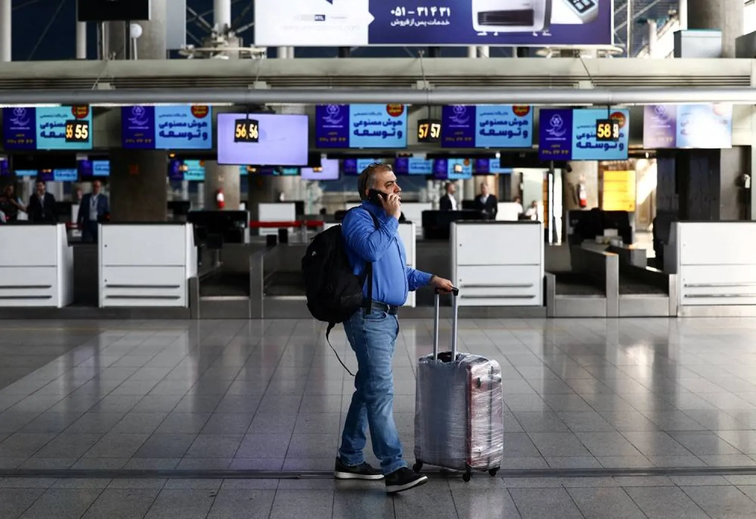 A passenger walks through the terminal hall after flights resumed at Imam Khomeini International Airport, amid a ceasefire between US and Iran, in Tehran, Iran, April 25, 2026. Majid Asgaripour/WANA (West Asia News Agency) via Reuters