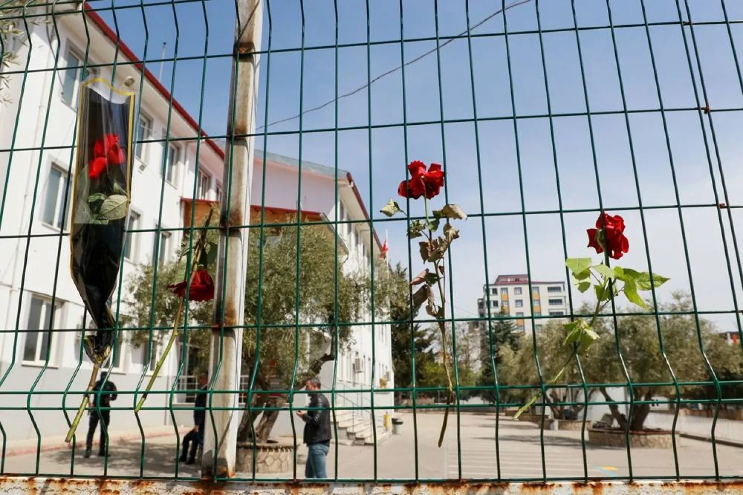 Flowers are hung on the fence of a school where a shooting took place, in the southeastern province of Kahramanmaras, Türkiye, April 16, 2026. (Reuters) 