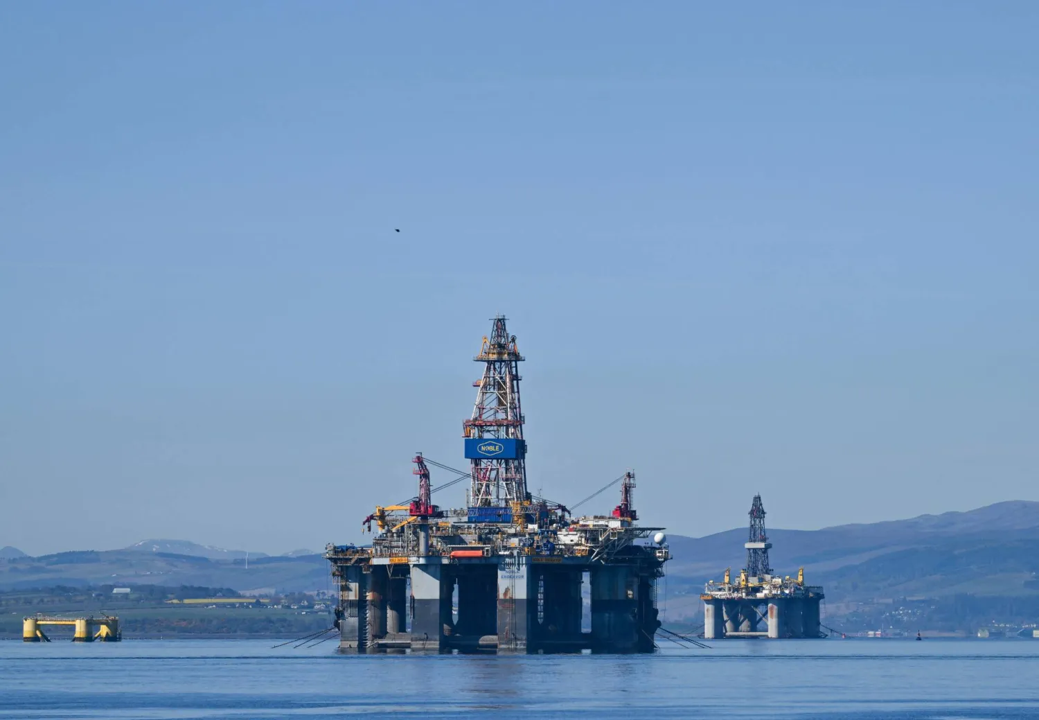 The Noble Endeavor (C) and Well-Safe Defender (R) oil rigs are seen on the Cromarty Firth on the north-east coast of Scotland on April 24, 2026. (AFP)