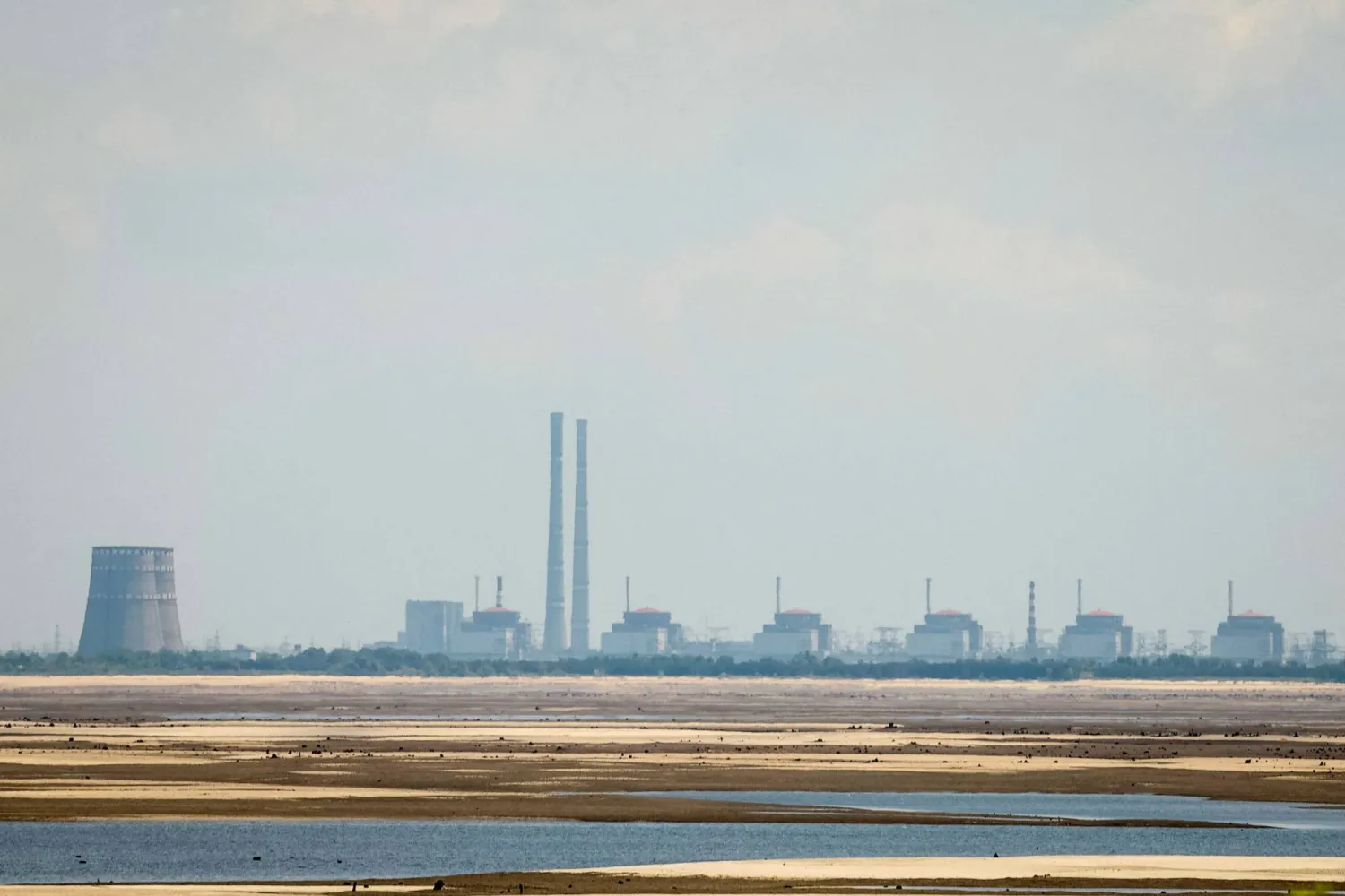 A view shows Zaporizhzhia Nuclear Power Plant from the bank of Kakhovka Reservoir near the town of Nikopol after the Nova Kakhovka dam breached, amid Russia's attack on Ukraine, in Dnipropetrovsk region, Ukraine June 16, 2023. (Reuters)