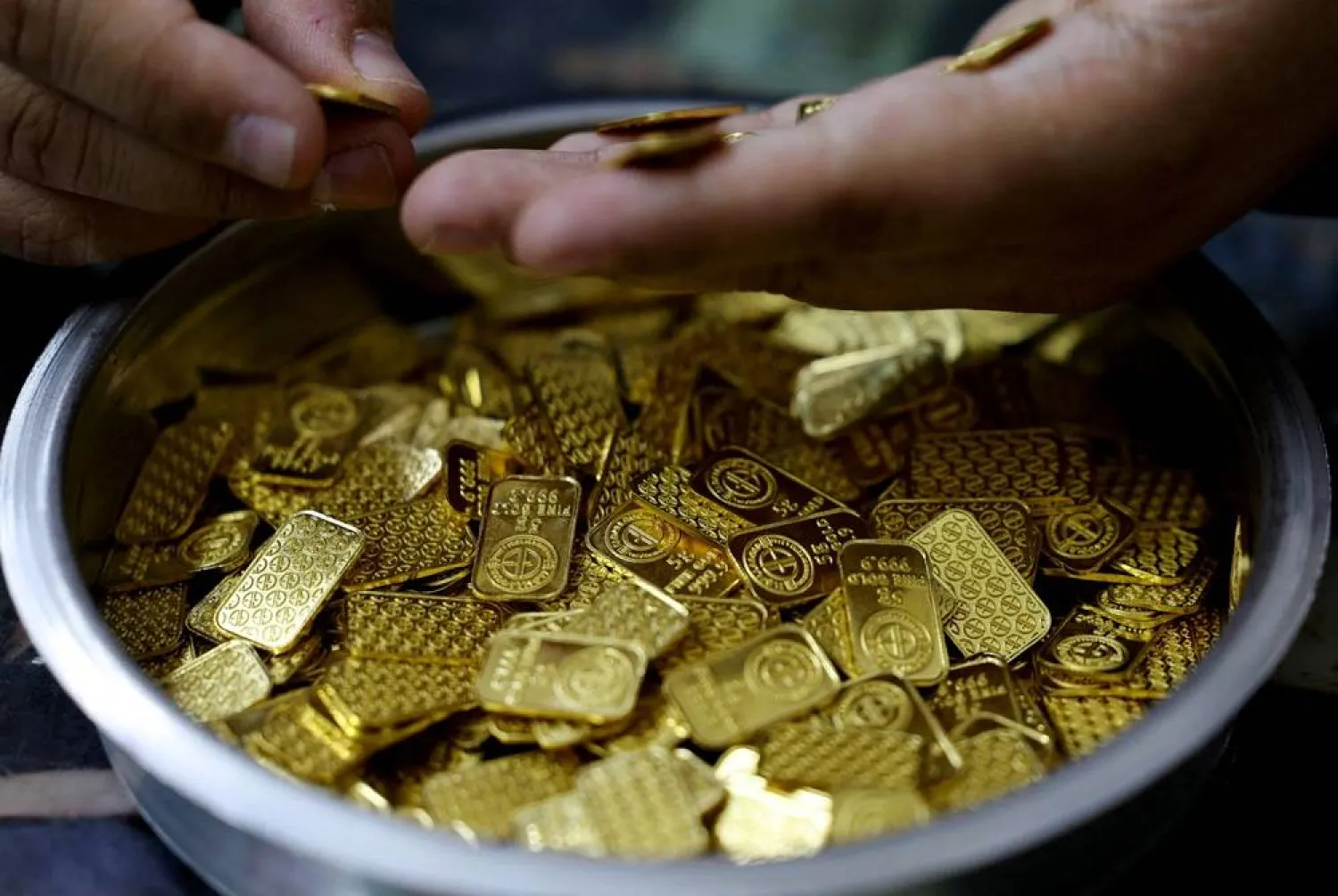 A jeweller holds gold bars in Cairo, Egypt, March 9, 2026. (Reuters)