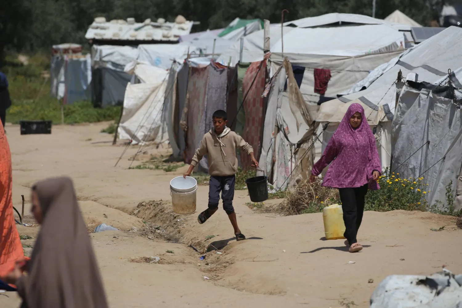People fetch drinking water at the Bureij camp for Palestinian refugees in the central Gaza Strip on April 28, 2026. (Photo by Eyad Baba / AFP)