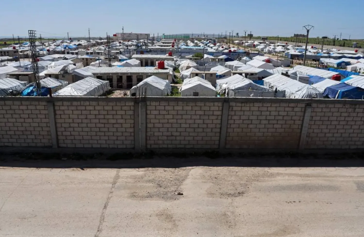 A brick wall surrounds a tent camp housing people with alleged ties to ISIS militants at Roj Camp in eastern Syria, Friday, April 24, 2026. (AP)
