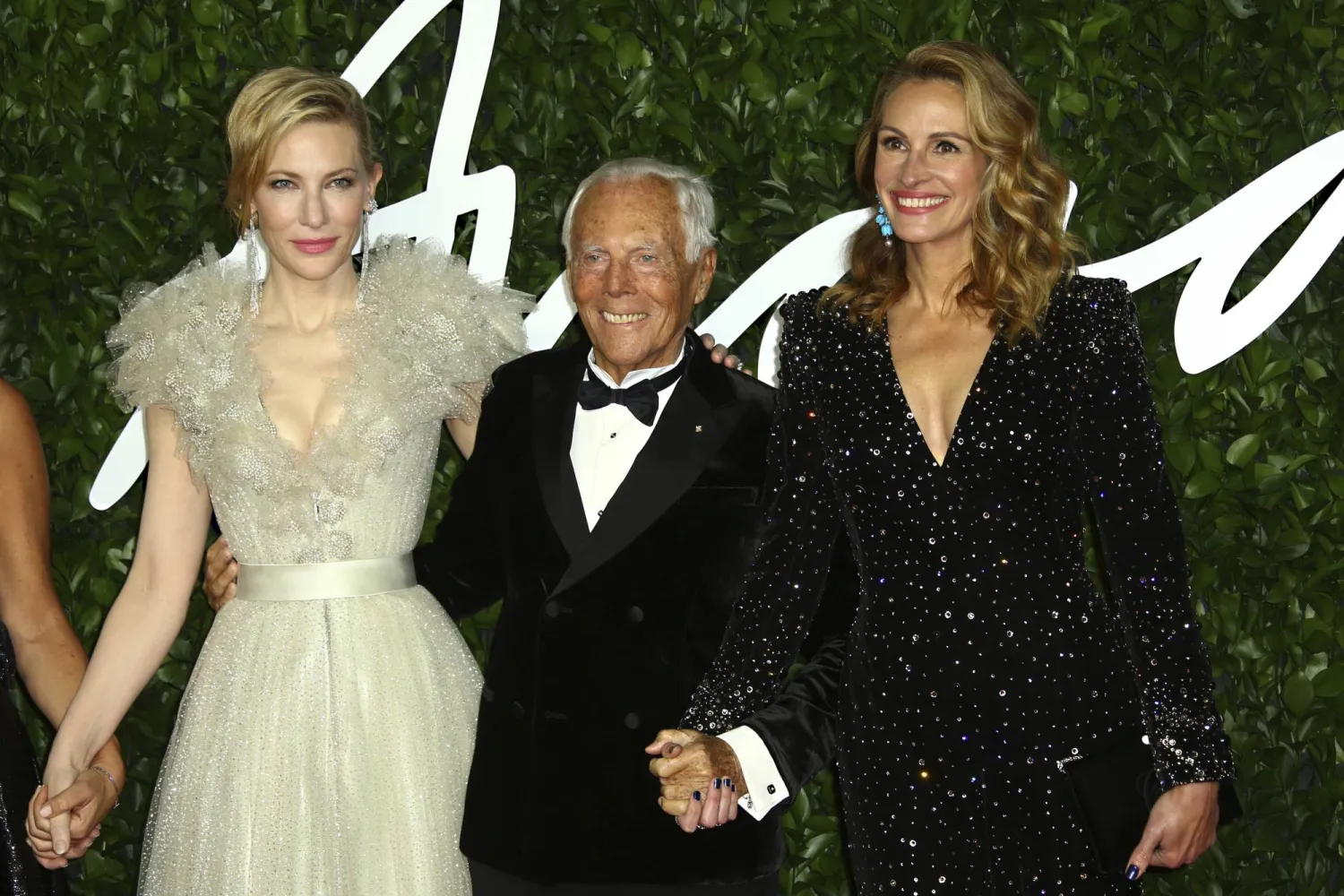 FILE - Actress Cate Blanchett, from left, designer Giorgio Armani, and actress Julia Roberts pose for photographers upon arrival at the British Fashion Awards in central London, Dec. 2, 2019. (Photo by Joel C Ryan/Invision/AP)