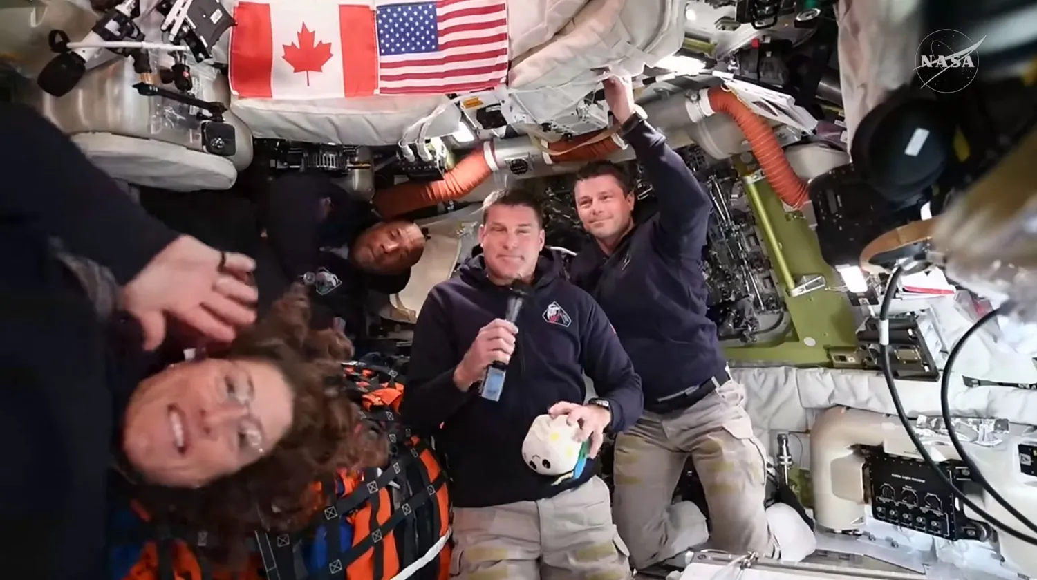This screengrab from a NASA live broadcast video shows (L-R) NASA astronaut and Artemis II Mission Specialist Christina Koch, NASA astronaut and Artemis II pilot Victor Glover, Canadian Space Agency astronaut Artemis II Mission Specialist Jeremy Hansen and NASA astronaut and Artemis II Commander Reid Wiseman during a press call as they travel to the Moon in the Orion spacecraft, on April 3, 2026.  (Photo by NASA / AFP) 