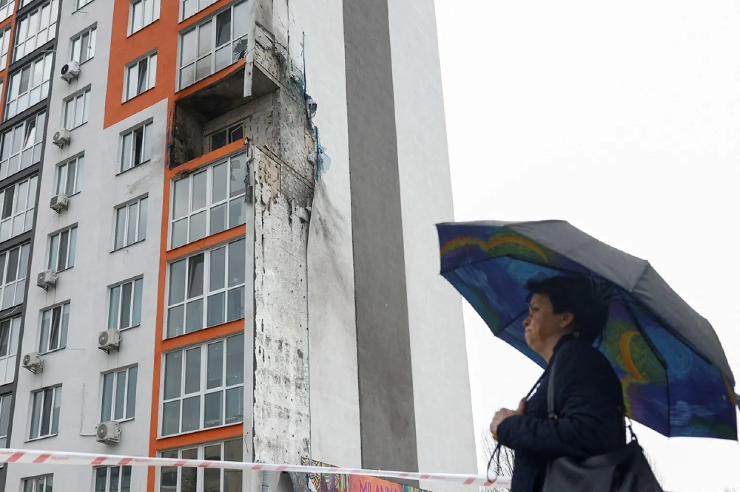 A resident stands in front of an apartment building hit by a Russian drone strike, amid Russia's attack on Ukraine, in the town of Obukhiv, Kyiv region, Ukraine April 3, 2026. (Reuters) 