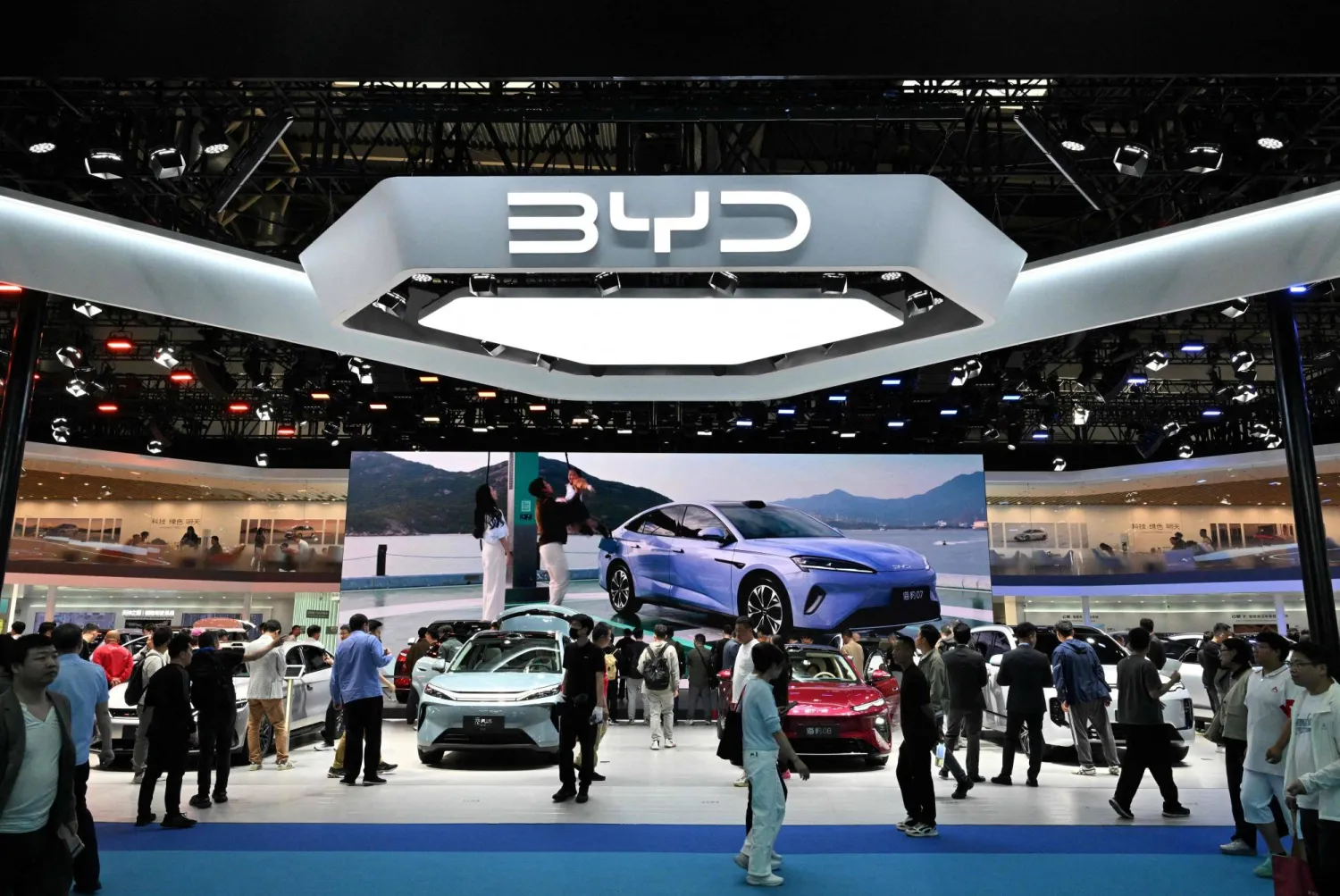 People visit the BYD booth at the Beijing Auto Show in Beijing on April 30, 2026. (Photo by Adek BERRY / AFP)