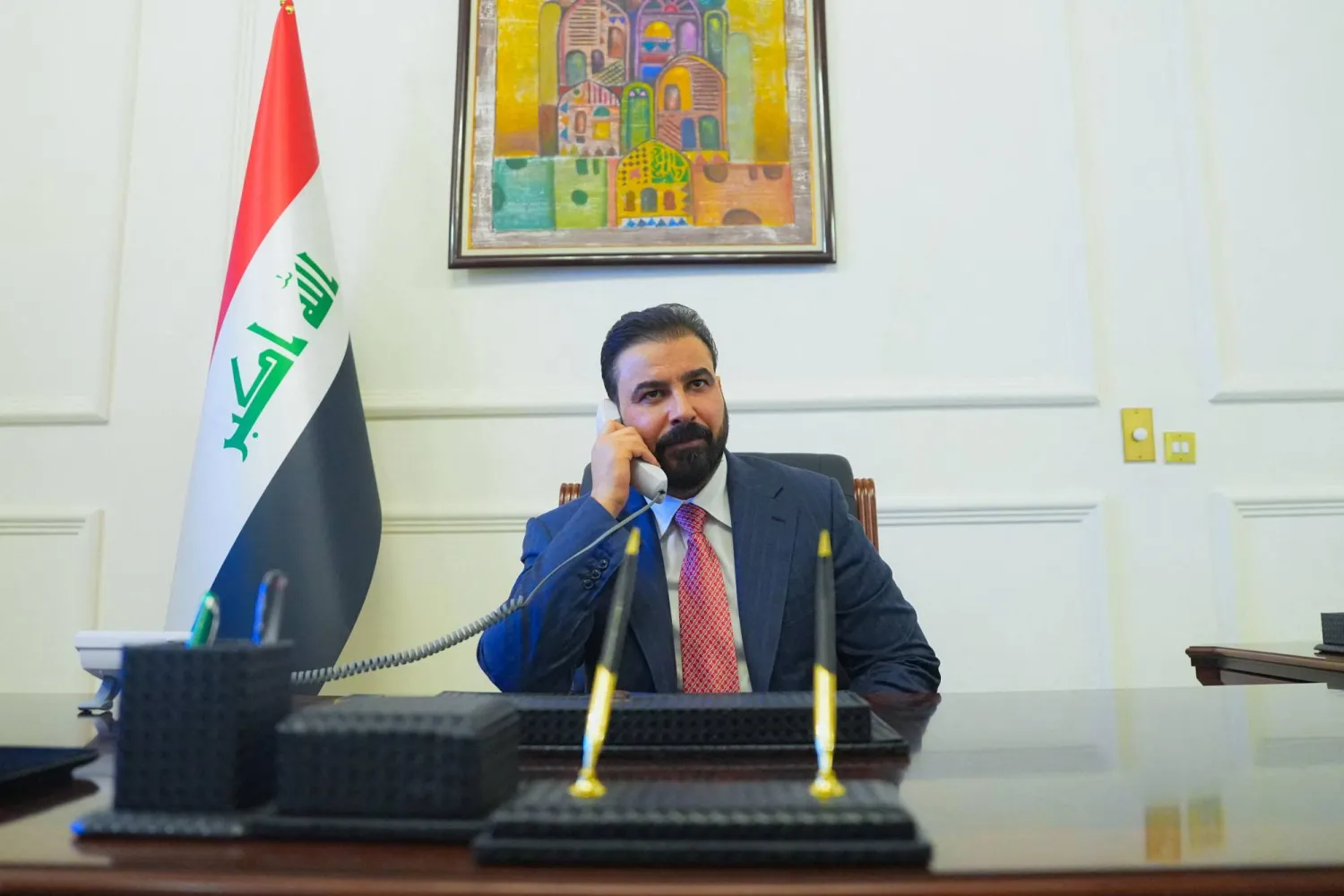 New Iraqi Prime Minister-designate Ali al-Zaidi, uses a phone at his office in Baghdad, Iraq, April 28, 2026. (Iraqi Prime Minister’s Media Office/Handout via Reuters). 