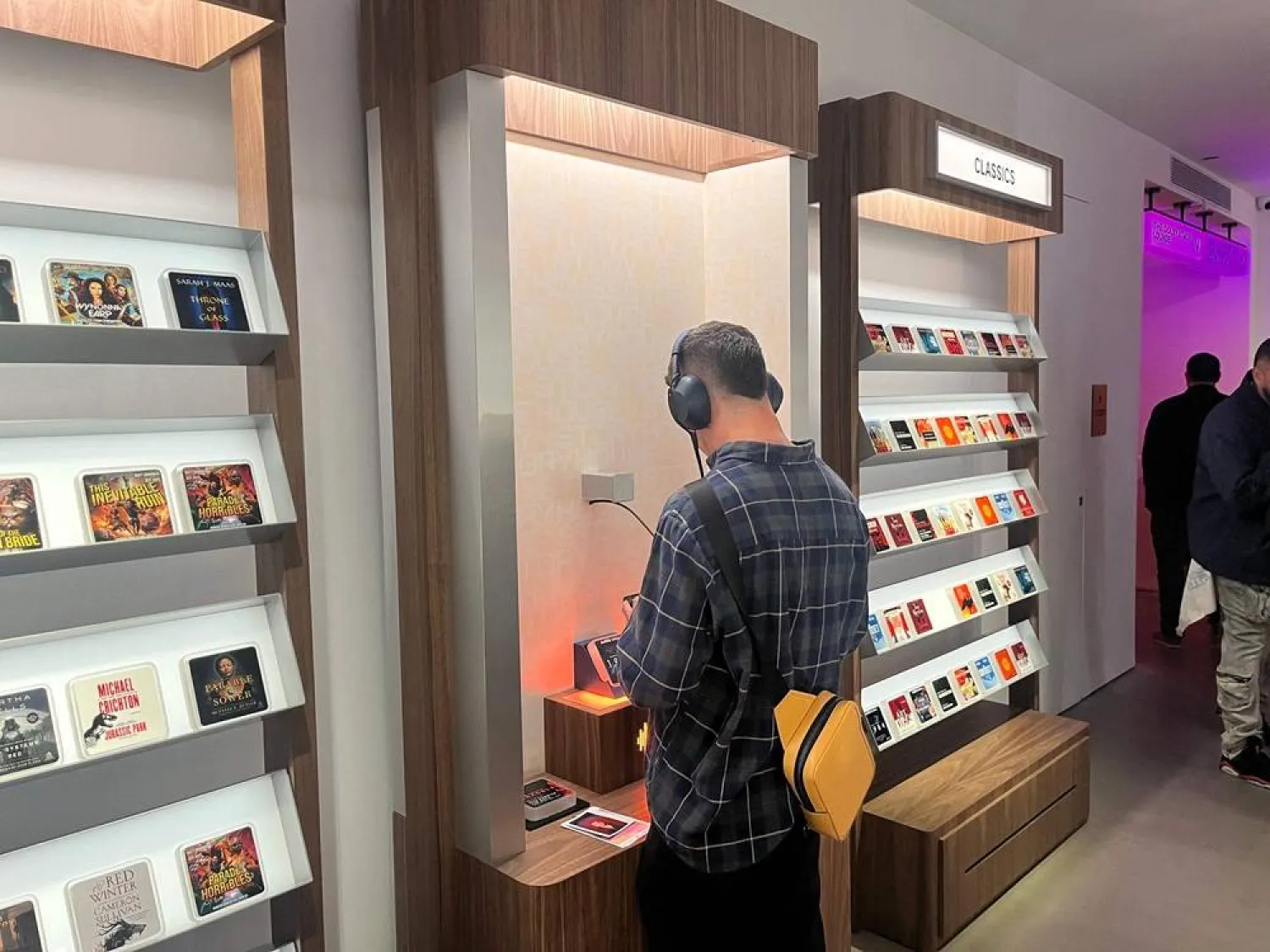  A customer shops at the Audible Story House in New York, on April 30, 2026. The pop-up store labeled as a "bookless bookstore" is dedicated to audiobooks. (AFP) 