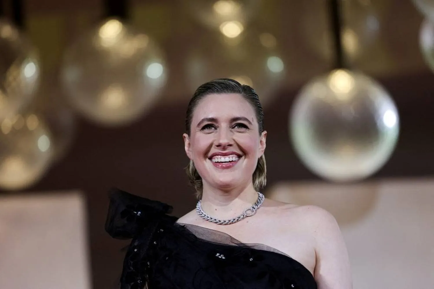 Cast member Greta Gerwig poses on the red carpet for the screening of the movie "Jay Kelly" in competition, at the 82nd Venice Film Festival, in Venice, Italy, August 28, 2025. (Reuters) 