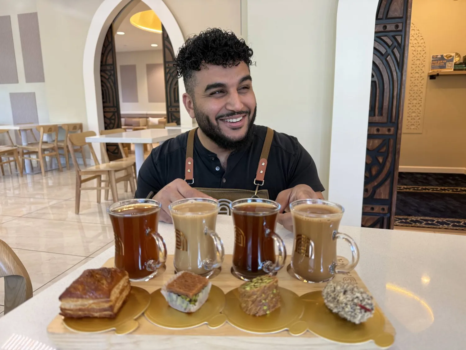Franchisee Ahmad Badr serves a drink and treat sampler at Arwa Yemeni Coffee on April 6, 2026, in Sunnyvale, Calif. (AP) 