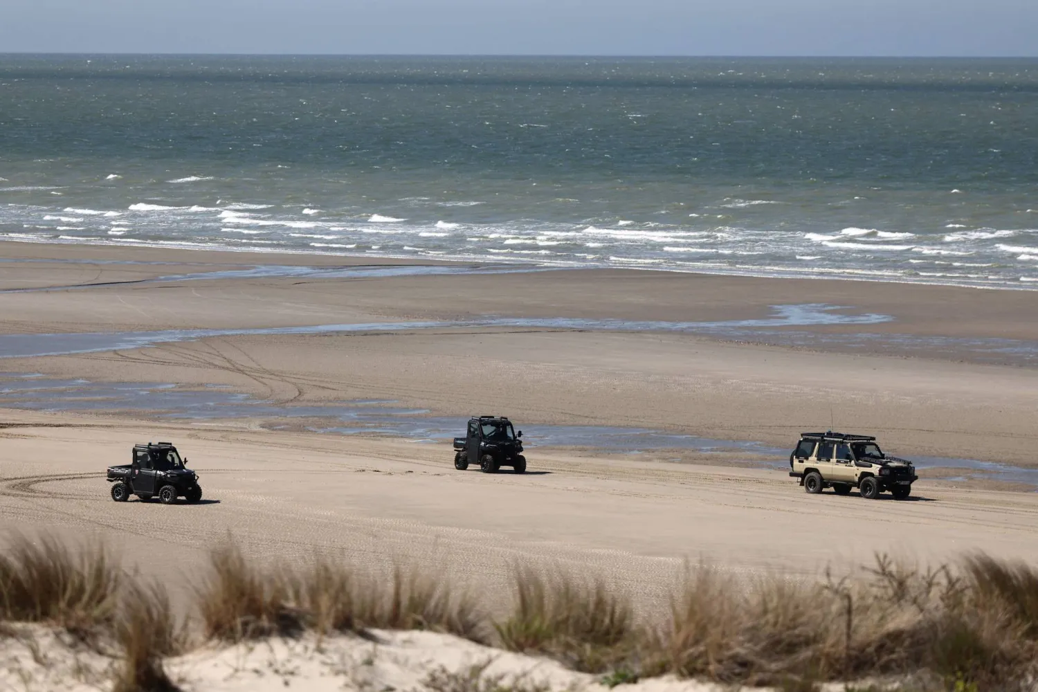 French police's vehicles are seen on the beach during a presentation of the operational resources used to counter illegal immigration, on the shores of Zuydcoote, near Dunkirk, on April 23, 2026. (Photo by Sameer AL-DOUMY / AFP)