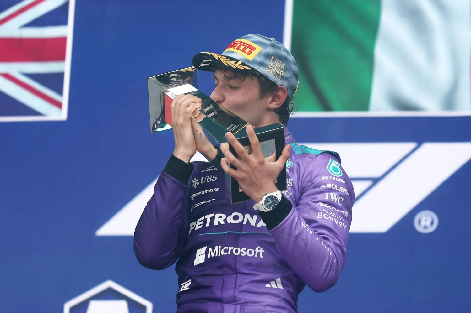 MIAMI, FLORIDA - MAY 03: Race winner Andrea Kimi Antonelli of Italy and Mercedes AMG Petronas F1 Team kisses his trophy on the podium during the F1 Grand Prix of Miami at Miami International Autodrome on May 03, 2026 in Miami, Florida. Peter Fox/Getty Images/AFP (Photo by Peter Fox