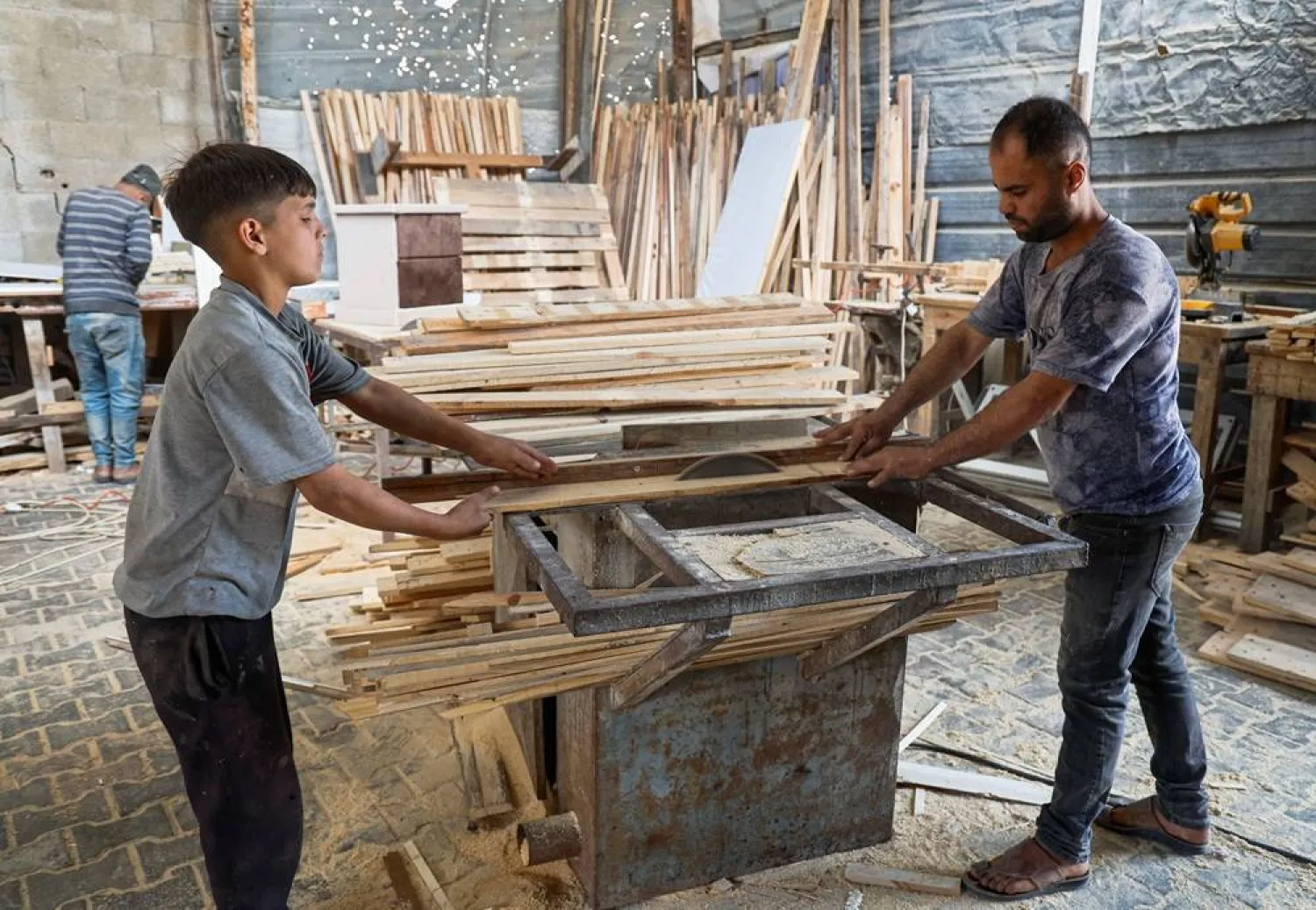  Palestinian carpenter Mohammed Wafi builds furniture from recycled wooden pallets in his workshop amid shortages of materials in Khan Younis, in the southern Gaza Strip, May 2, 2026. (Reuters)