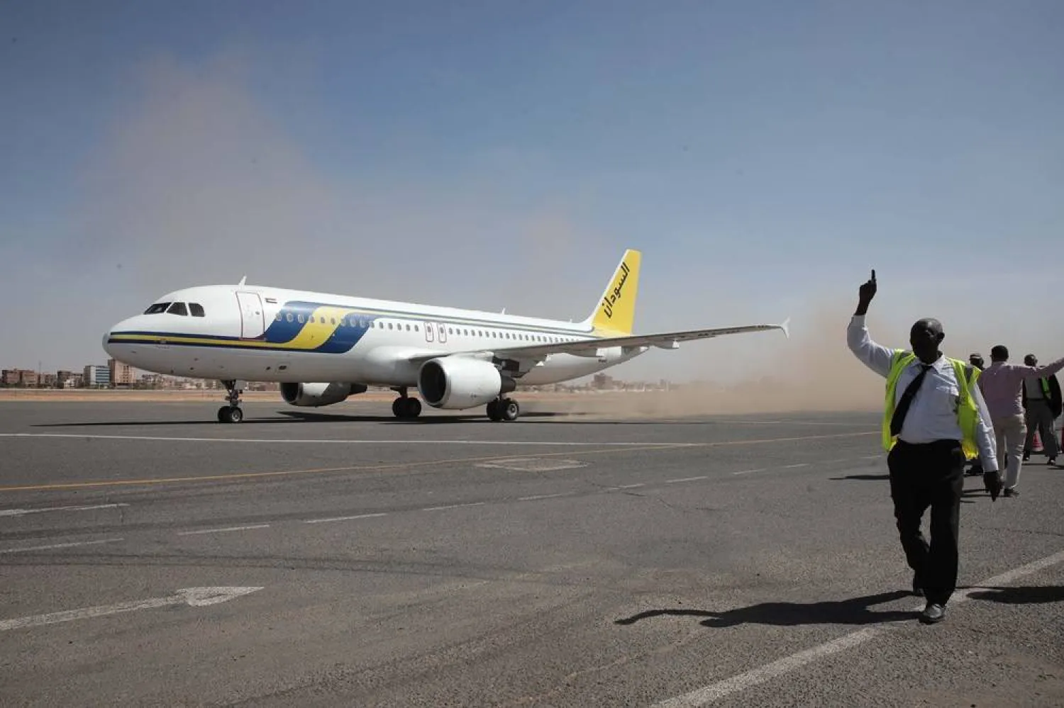 Khartoum International Airport ground workers greet the first domestic Sudan Airways flight landing from Port Sudan, in Khartoum, Sudan, on Feb. 1, 2026. (AP) 
