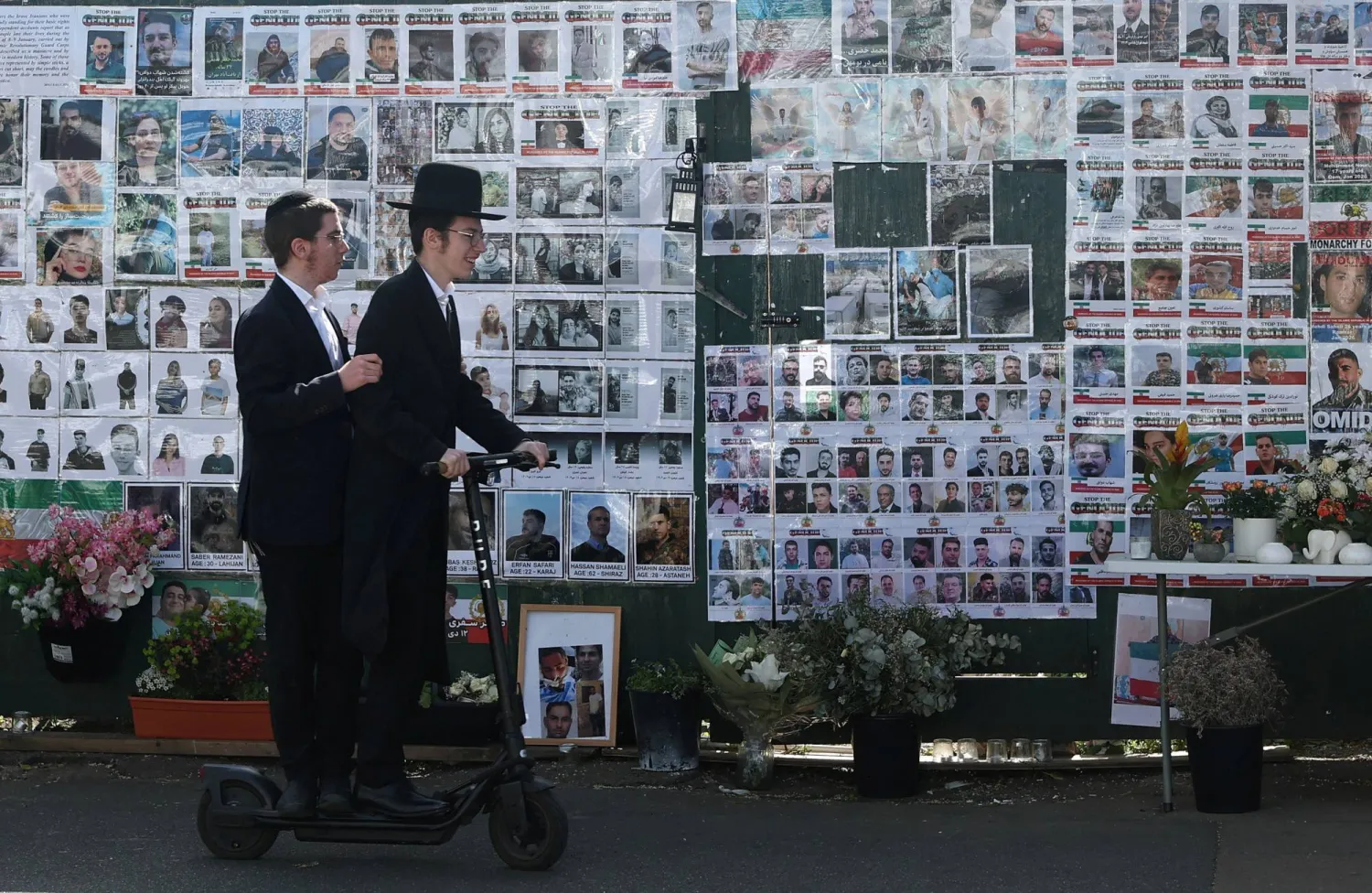 Members of the Jewish community ride past a memorial wall, dedicated both to the victims of the October 7 attacks in Israel and Iranians killed in recent protests in Iran, on Limes Avenue in Golders Green after a suspected arson attack in London, Britain, April 28, 2026. REUTERS/Toby Melville