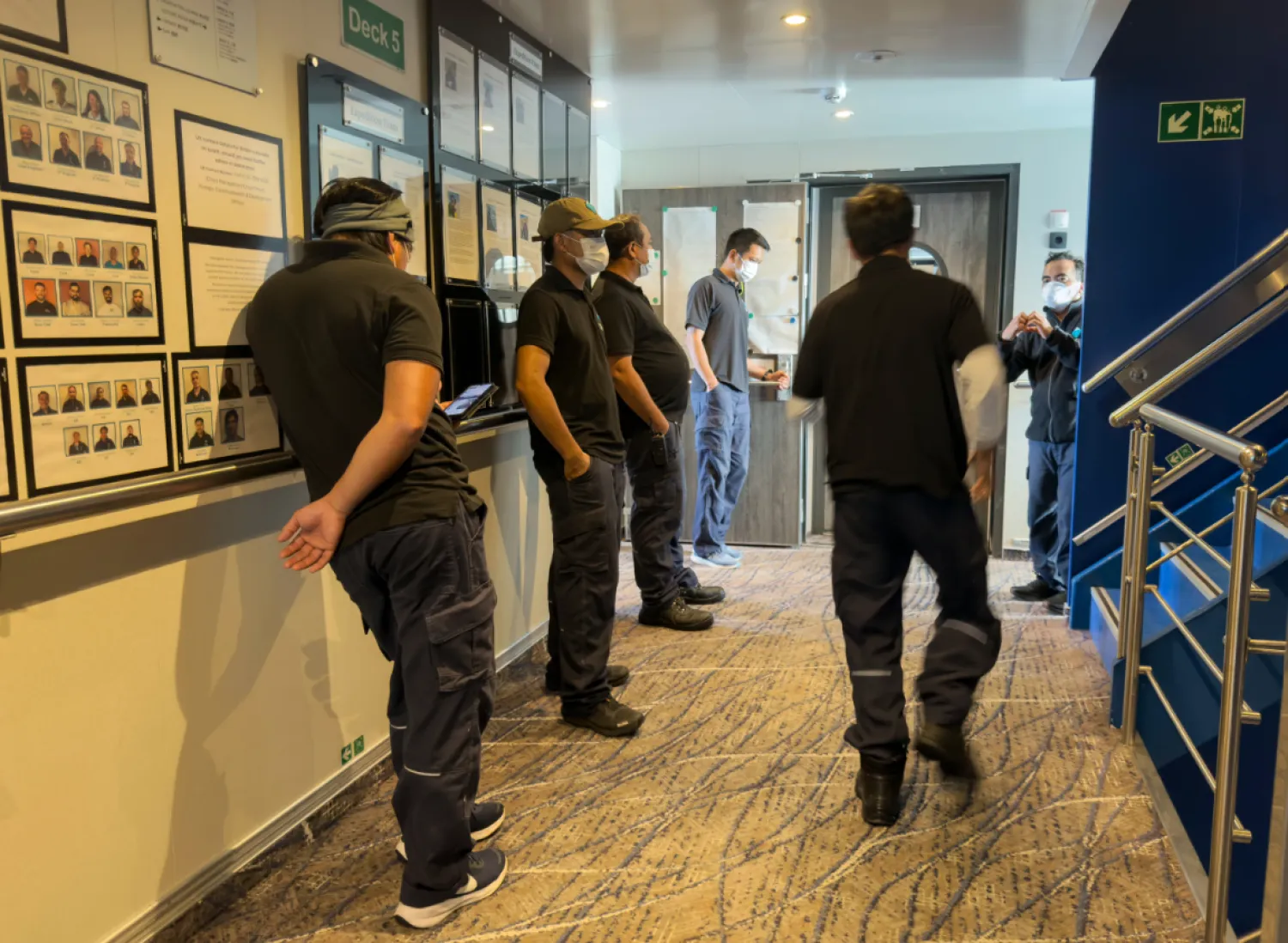 Crew members of the hantavirus-stricken cruise ship, MV Hondius, wait their turns for a first interview with epidemiologists, during the voyage to Spain’s port of Tenerife, May 6, 2026. (AP Photo)
