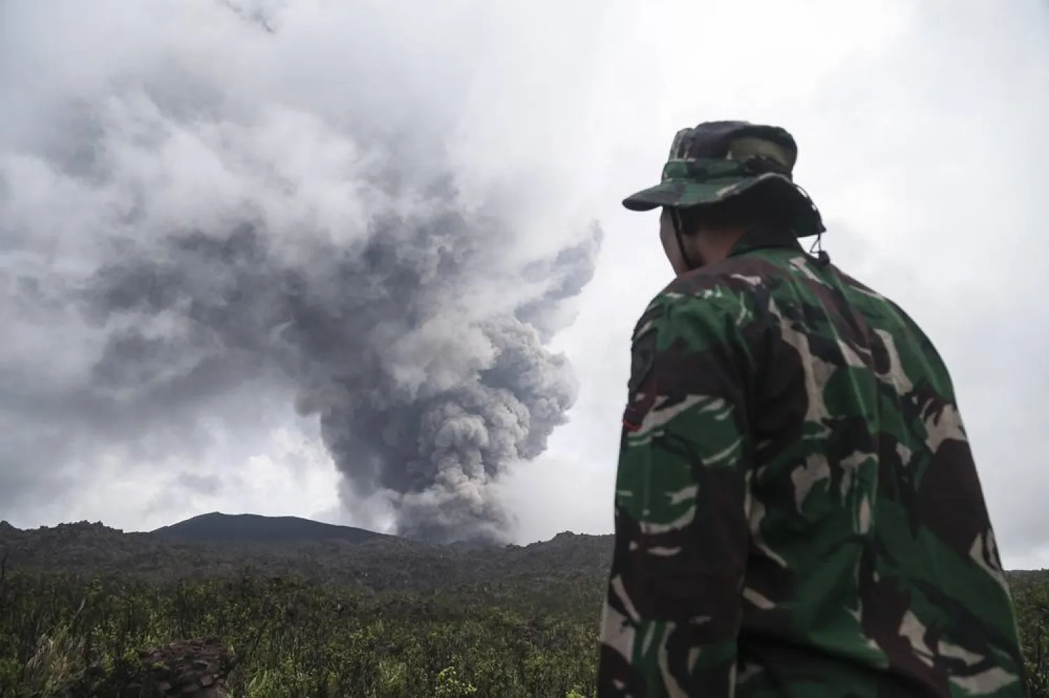 A rescuer looks on Mount Dukono Volcano during its eruption in North Halmahera, Indonesia, 09 May 2026. (EPA)