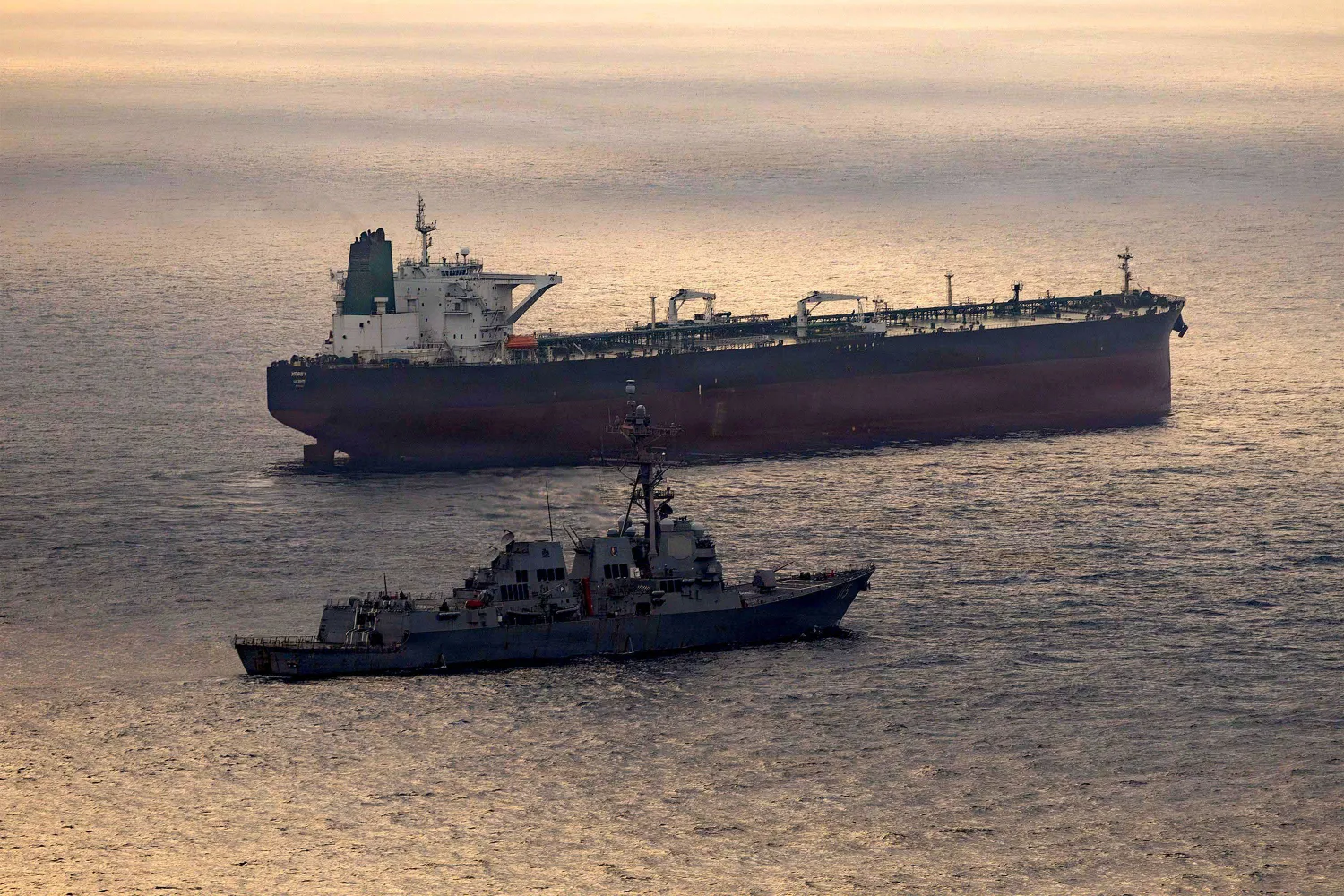 This US Navy handout photo released on May 8, 2026 by US Central Command Public Affairs, shows the Arleigh Burke-class guided-missile destroyer USS Rafael Peralta (DDG 115) implementing a maritime blockade against the Iran-flagged crude oil tanker vessel Herby while the latter was attempting to sail toward an Iranian port, on April 24, 2026. (US Navy / AFP)
