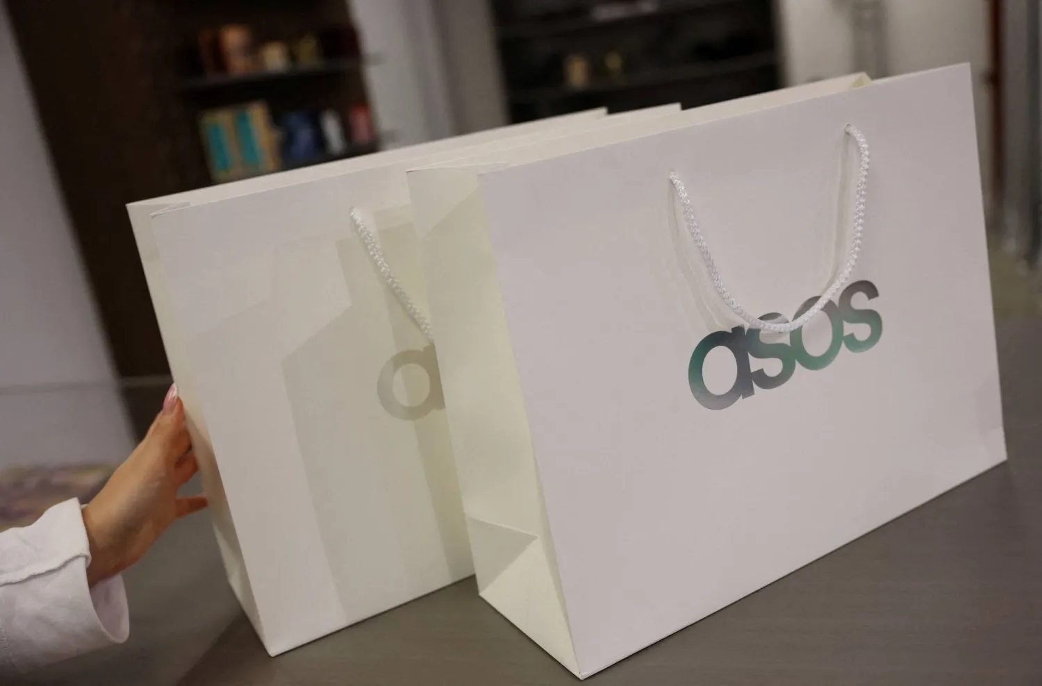 FILE PHOTO: Branded shopping bags are displayed in an ASOS pop-up store in London, Britain, November 12, 2025. REUTERS/Hannah McKay/File Photo