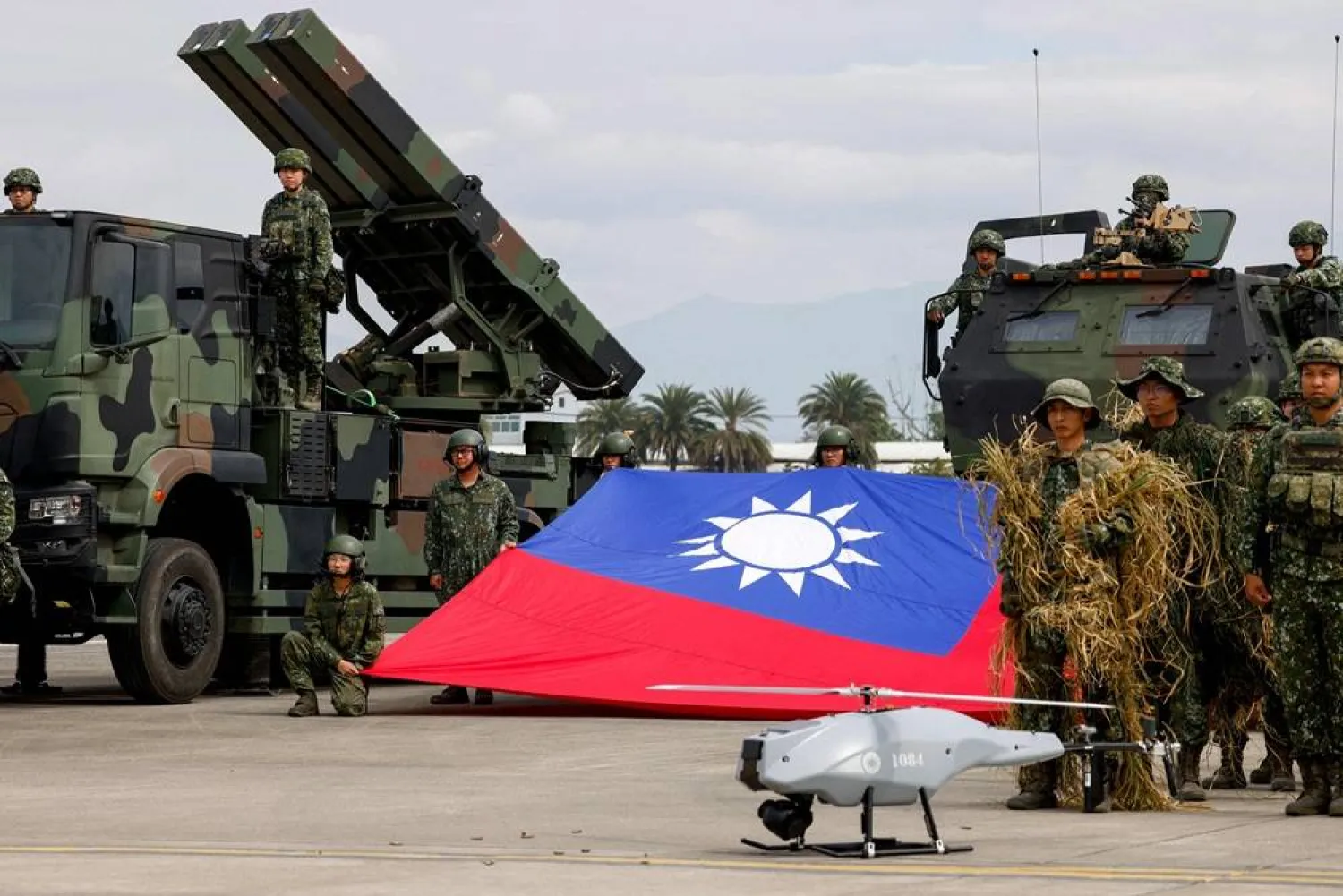 Taiwanese soldiers pose with a Taiwanese flag near a Sky Sword II surface-to-air missile launcher and a military UAV during an annual military exercise ahead of Lunar New Year in Taichung, Taiwan, January 27, 2026. (Reuters)