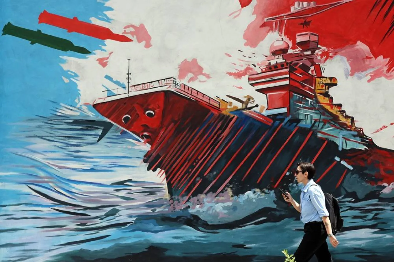 An Iranian walks next to a anti-US and Israel mural in a street in Tehran, Iran, 08 May 2026. (EPA)