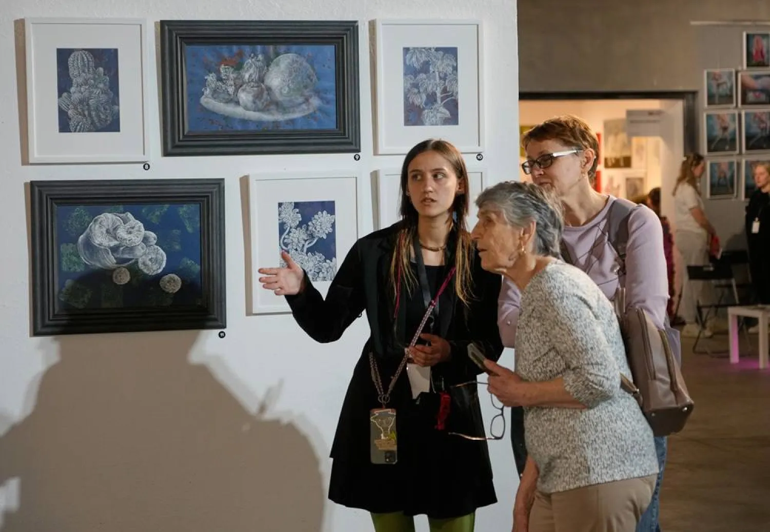  Visitors look at paintings by Ukrainian artists at the Art Kyiv 2026 Festival at the Art Ukraine Gallery in Kyiv, Ukraine, Friday, May 8, 2026. (AP) 