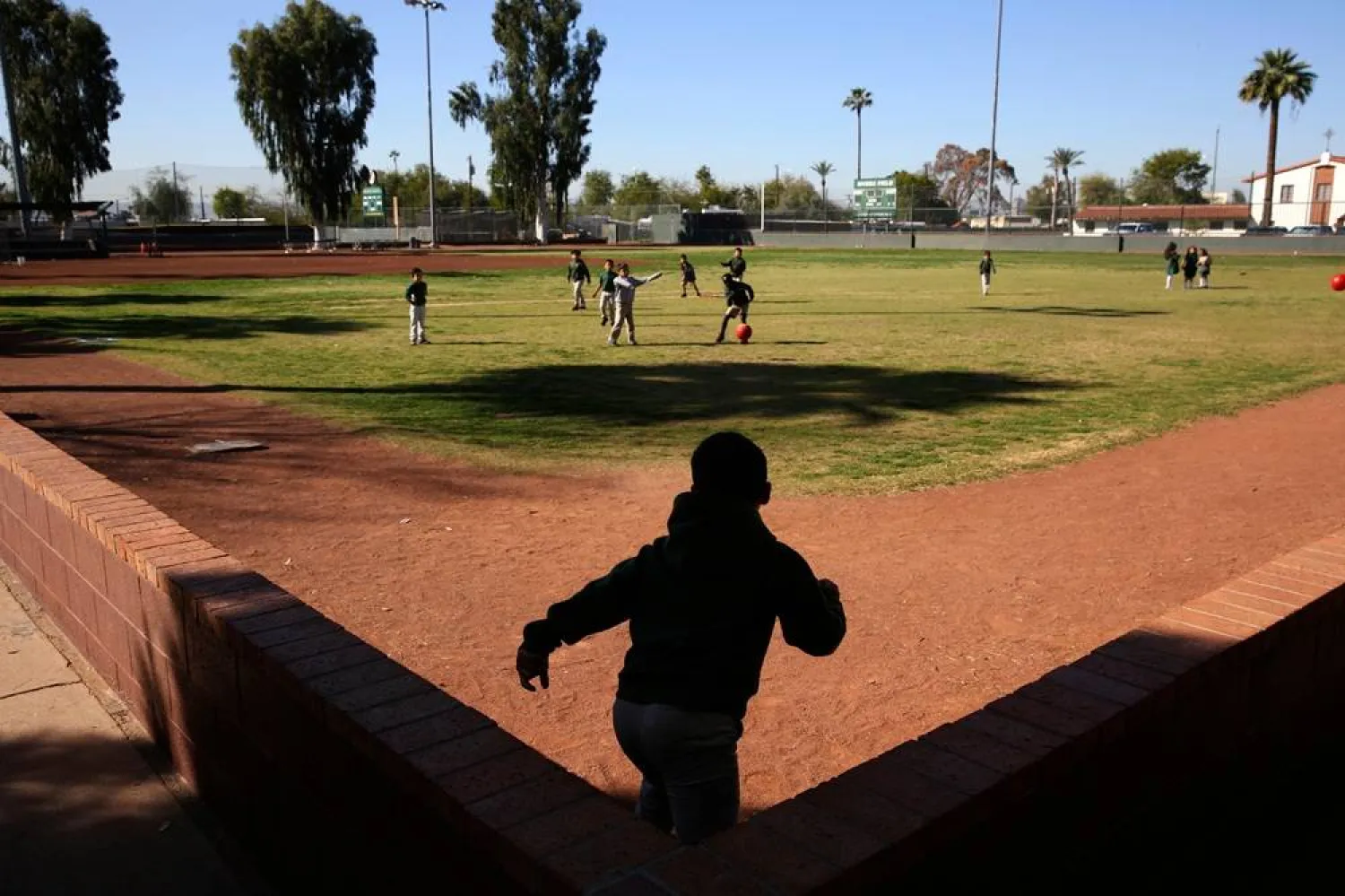 Students play ball during recess at the St. Agnes Elementary School in Phoenix, Ariz., on March 3, 2020. (AP) 