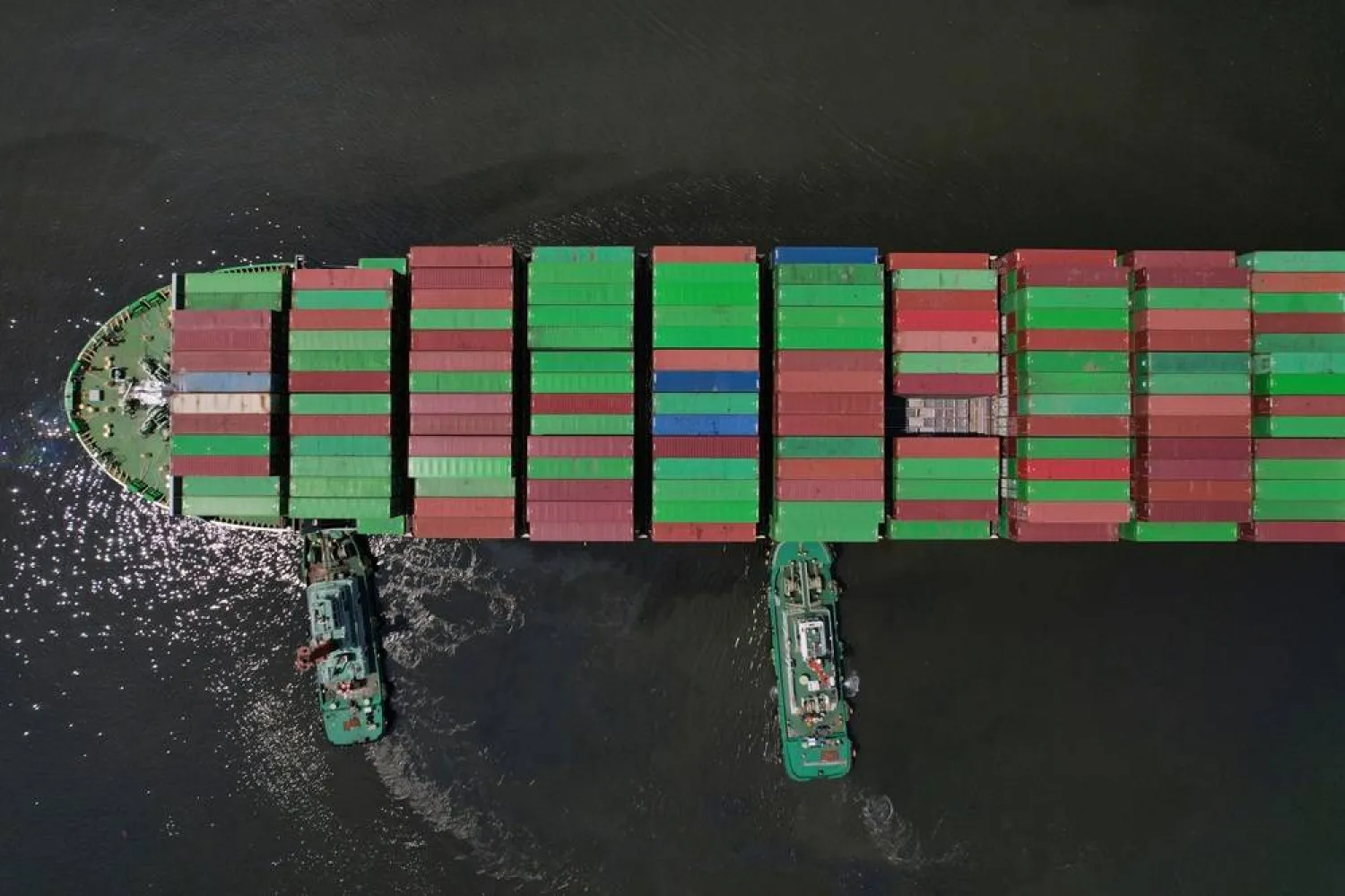Tugboats assist a container ship as it prepares to dock at the Manila International Container Terminal at the Philippine capital April 8, 2025. (AP)