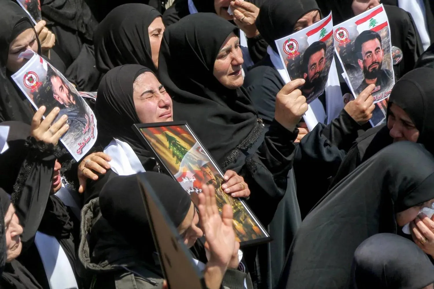 Women mourn during the funeral procession for three Lebanese Civil Defense members killed in an Israeli airstrike on the village of Majdal Zoun in southern Lebanon. (dpa) 