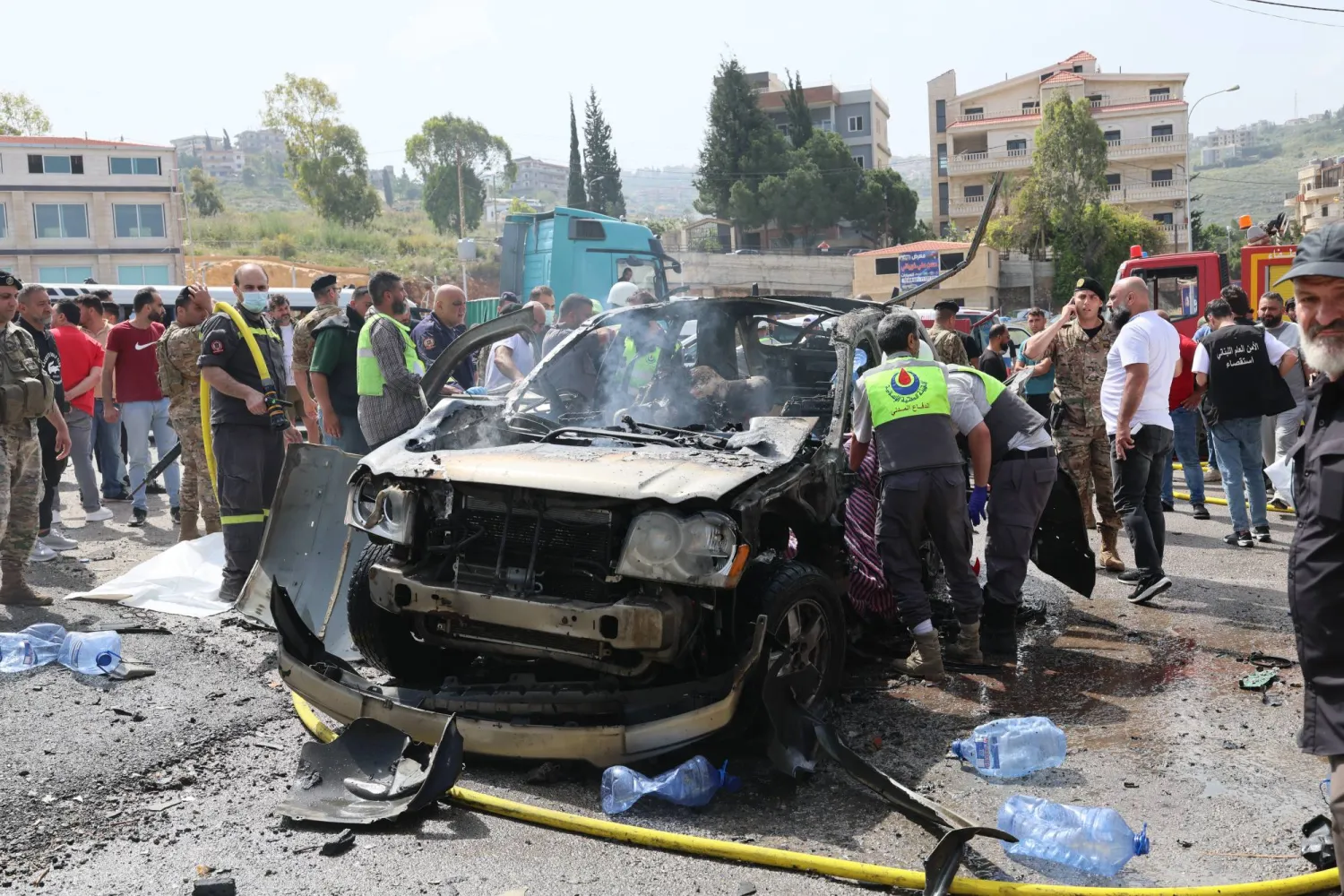Lebanese rescuers and army soldiers inspect the wreckage of a vehicle that was hit in an Israeli strike in Jiyeh town, south of Beirut, Lebanon, 13 May 2026. EPA/WAEL HAMZEH