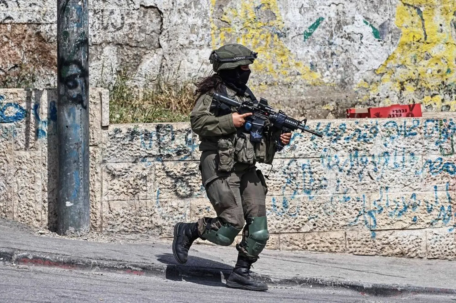An Israeli security force personnel patrols during a military raid at the Qalandia refugee camp, south of the city of Ramallah, in the Israeli-occupied West Bank, on May 6, 2026. (AFP)