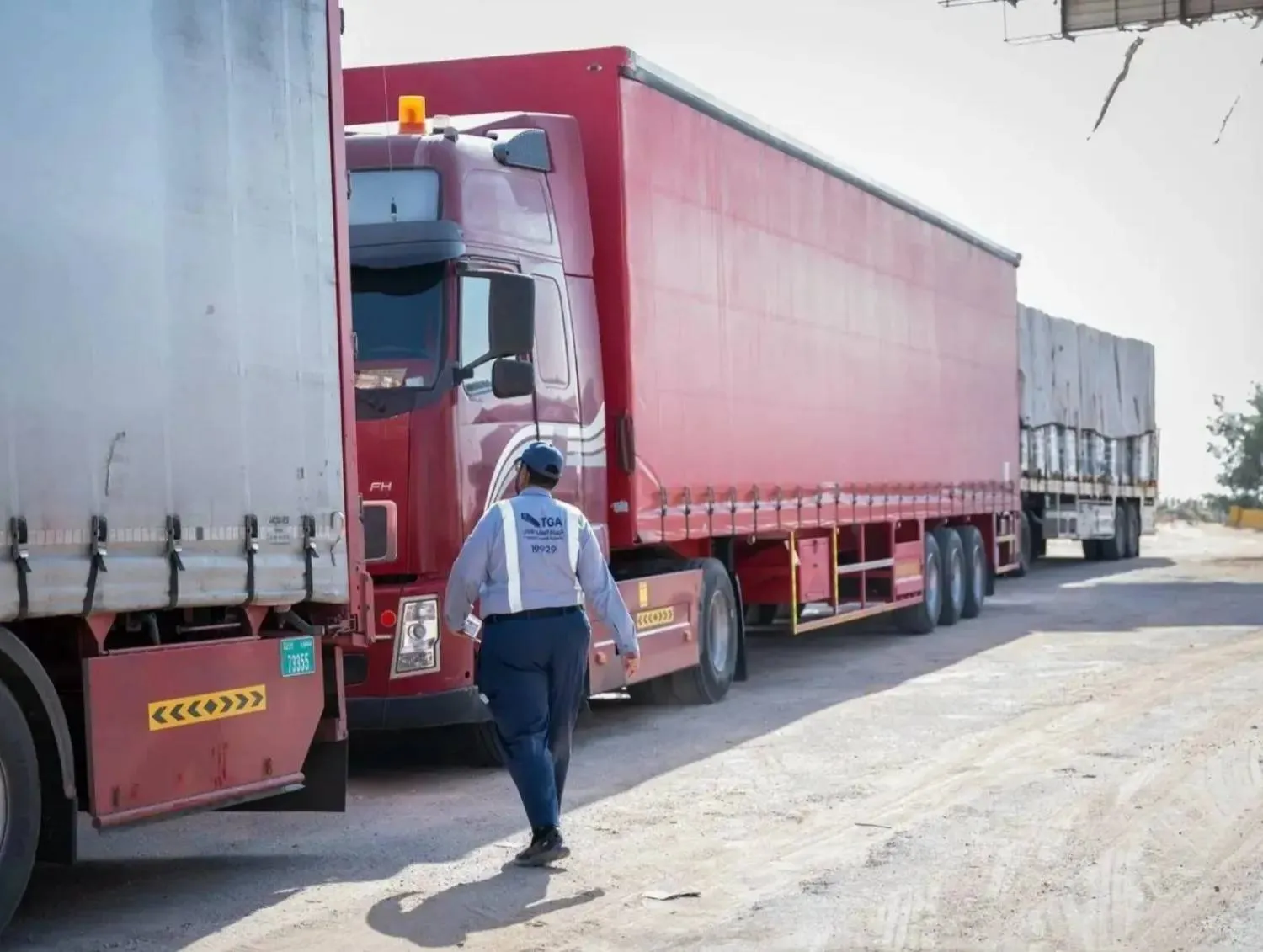 A worker from the Transport General Authority checking trucks (TGA)