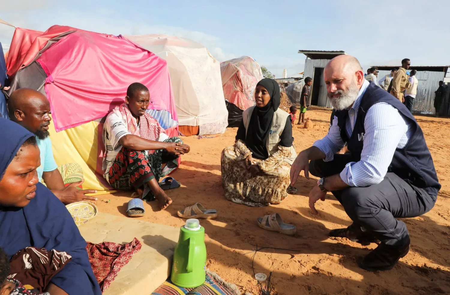 The World Food Program’s Assistant Executive Director for Program Operations, Matthew Hollingworth, talks to civilians during his visit to a camp for the internally displaced people to assess the knock on effects from the escalation in the Middle East, alongside drought and sharp cuts in humanitarian funding that are worsening hunger, in Kahda district of Mogadishu, Somalia May 7, 2026. REUTERS/Feisal Omar