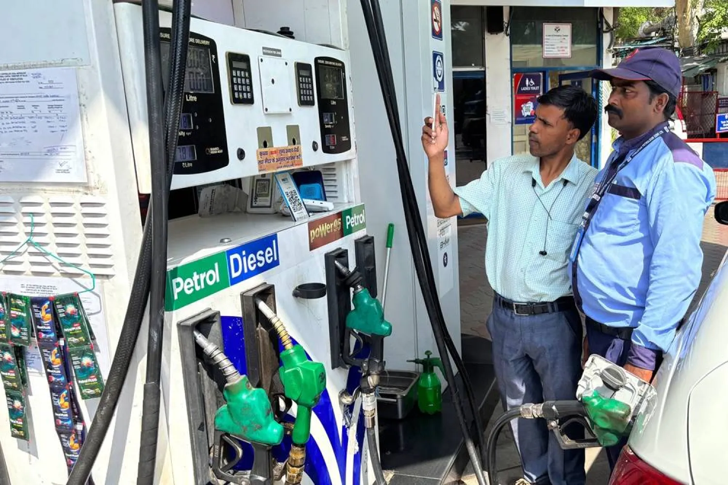  A commuter monitors the meter as an attendant refuels his vehicle at a filling station in New Delhi, India, Friday, May 15, 2026. (AP) 