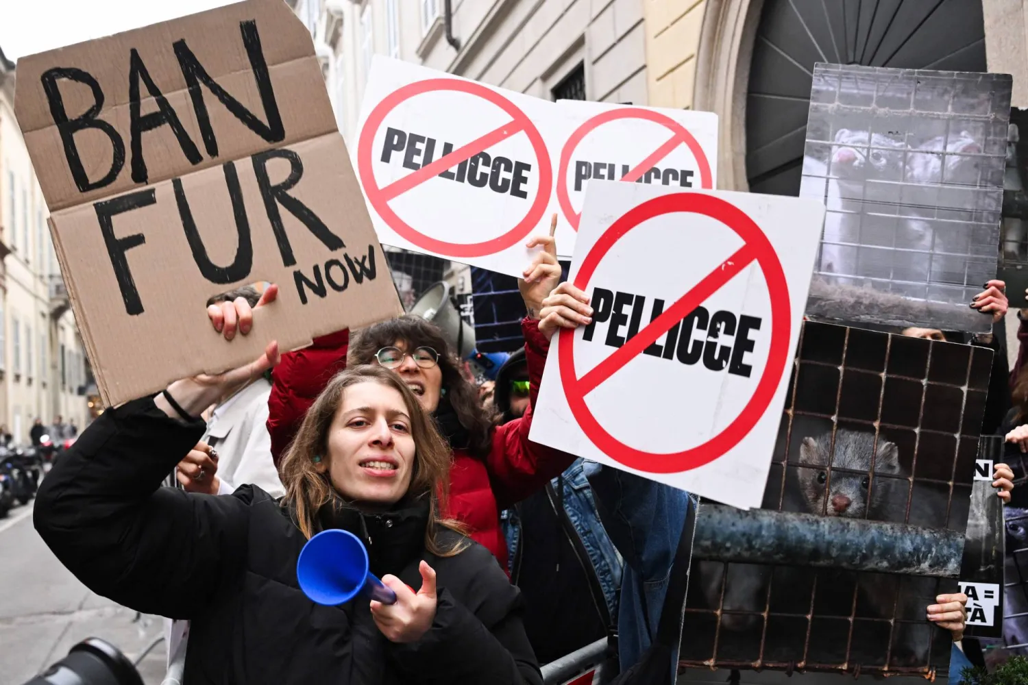 Protestors hold signs reading "Ban fur" ahead of the Giorgio Armani womens's ready-to-wear Fall/Winter 2026 collection fashion show as part of the Milan Fashion Week, in Milan on March 1, 2026. (AFP)