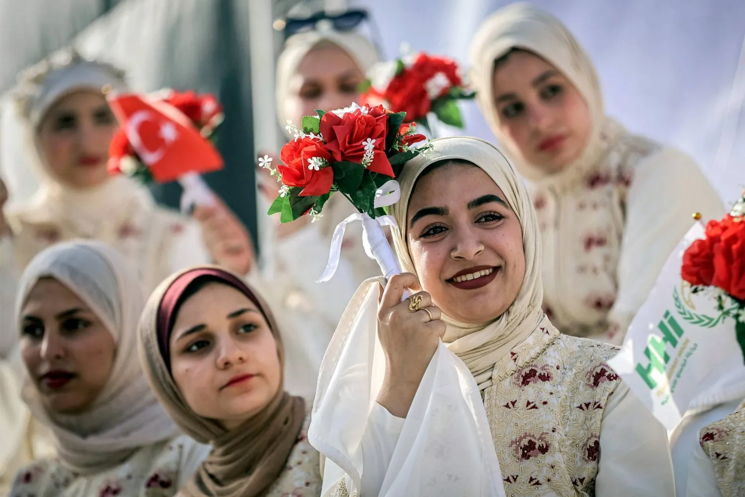  Brides waiting to be wed look on during a mass-wedding celebration for Palestinian couples organized by the Turkish Humanitarian Relief Foundation (IHH) in Gaza City on May 11, 2026. (AFP) 