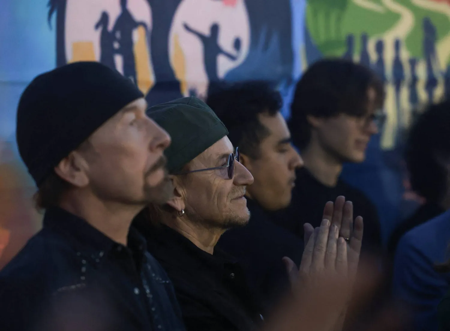 Irish rock band U2 lead singer Bono applauds beside guitarist The Edge during the match between Indonesia and Argentina for the Boys’ Shield final at the fifth Street Child World Cup football tournament, bringing together street-connected young people from 28 countries, in Texcoco, near Mexico City, Mexico, May 14, 2026, as the 2026 FIFA World Cup approaches in Mexico. REUTERS/Henry Romero