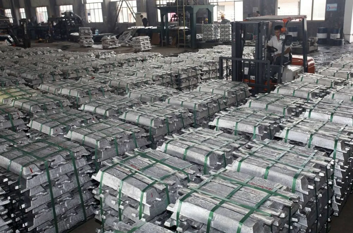A worker drives a forklift to transport aluminum bars at a factory in Anshun, Guizhou province, China, in this July 1, 2013. (Reuters)