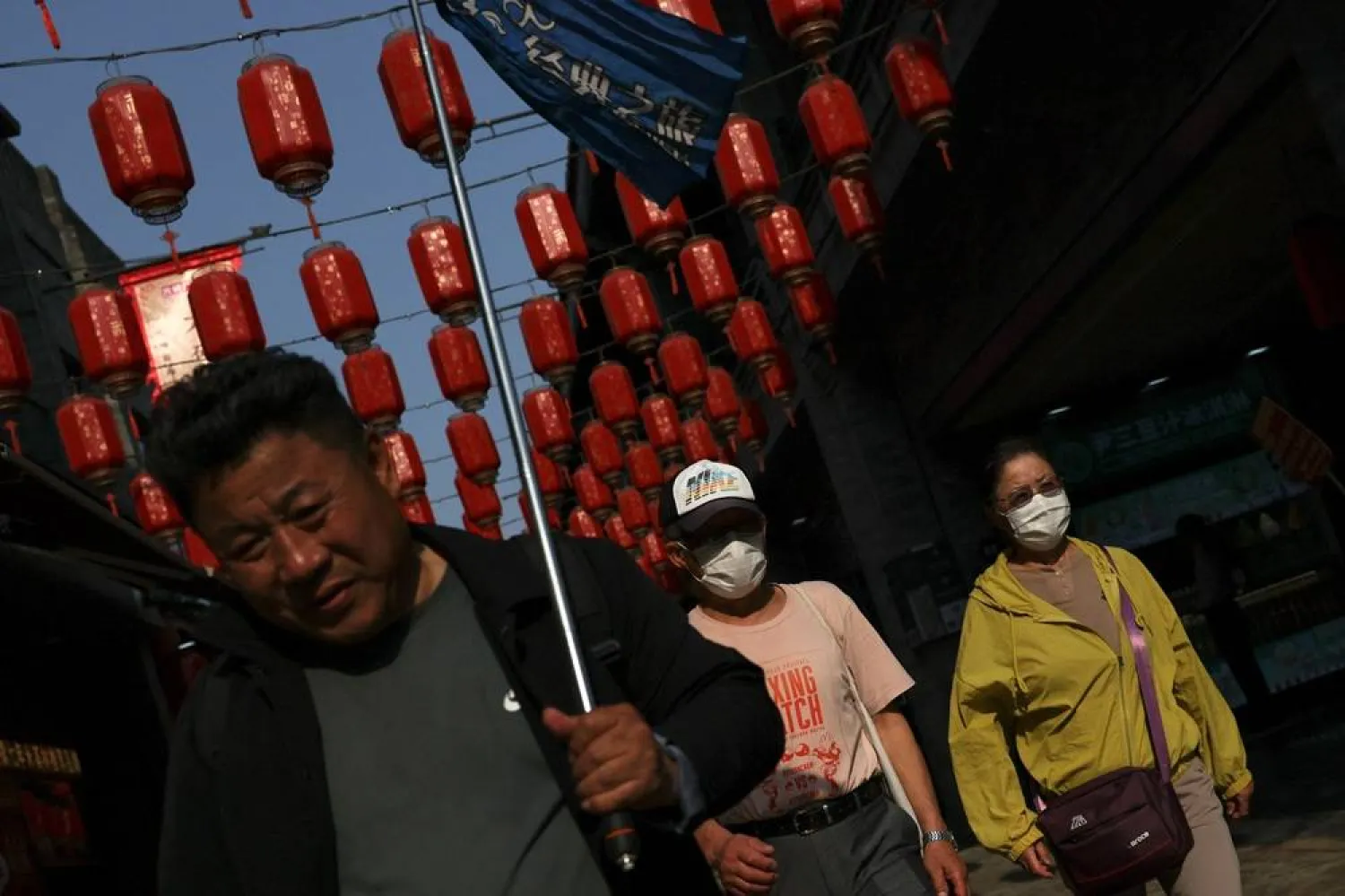  People walk on a street decorated with lanterns at Qianmen area, ahead of US President Donald Trump's state visit to China, in Beijing, China, May 12, 2026. (Reuters)