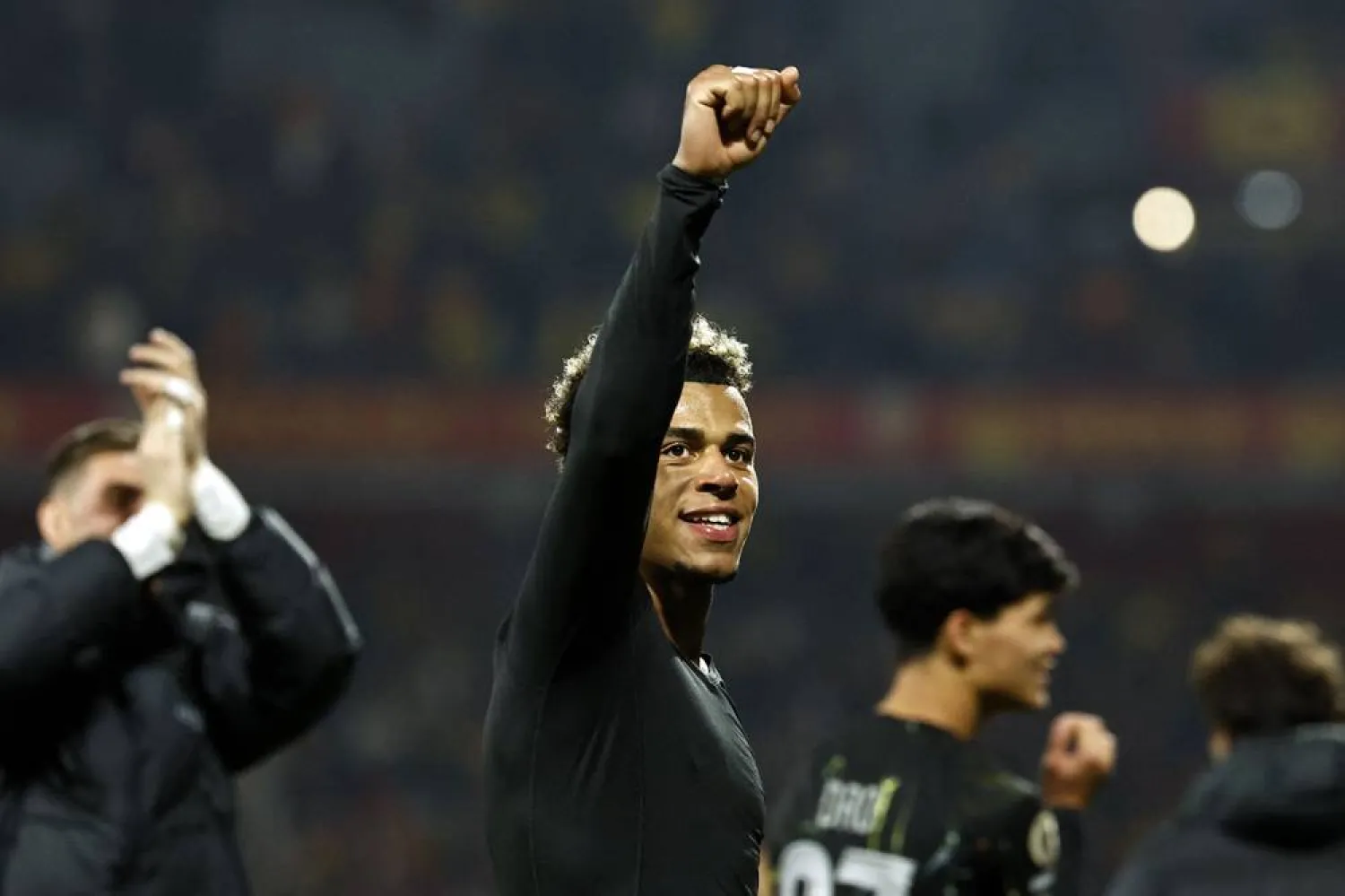 Paris Saint-Germain's French midfielder #14 Desire Doue celebrates his team victory at the end of the French L1 football match between RC Lens and Paris Saint-Germain (PSG) at the Stade Bollaert-Delelis stadium in Lens on May 13, 2026. (AFP)