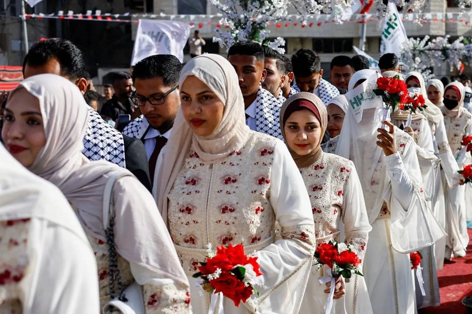  Palestinians attend a mass wedding for 50 couples organized by the IHH Humanitarian Relief Foundation in Gaza City, May 11, 2026. (Reuters)