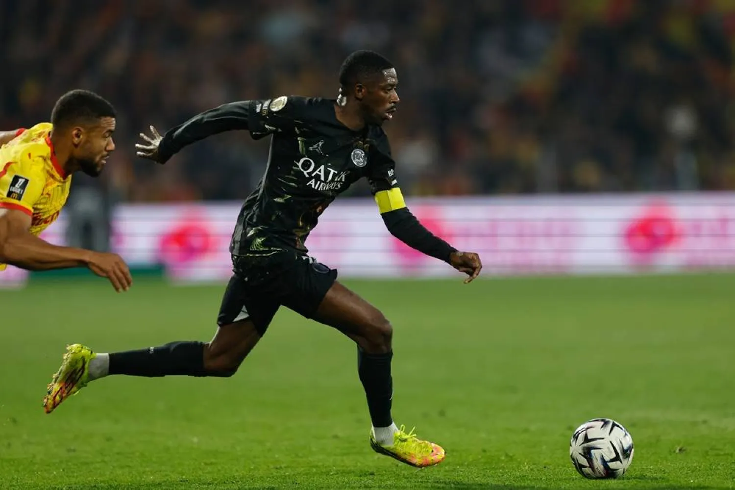PSG's Ousmane Dembele runs with the ball during the French League One soccer match between Lens and Paris Saint Germain, in Lens, northern France, Wednesday, May 13, 2026. (AP)