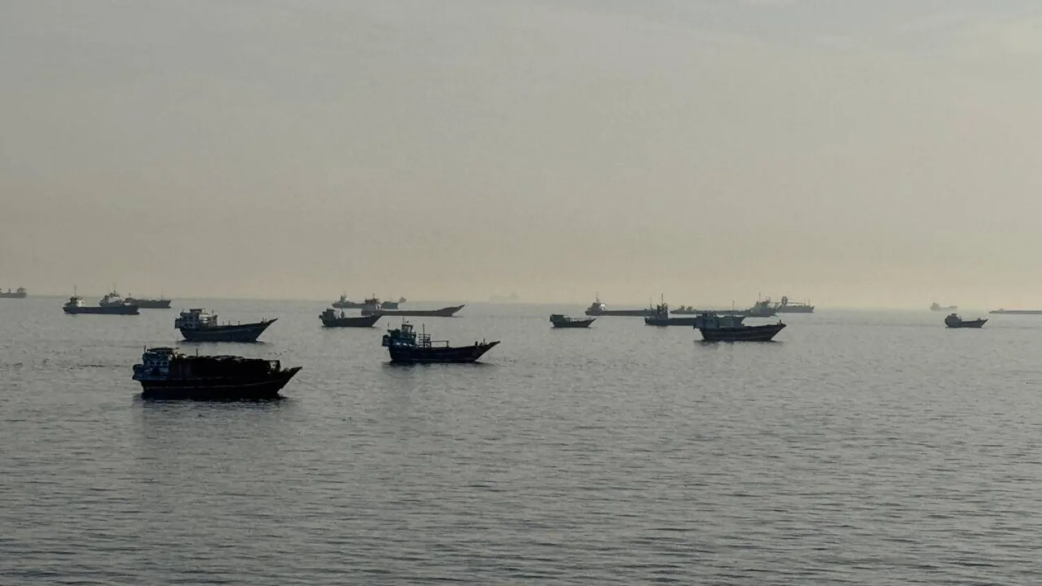 Vessels are seen anchored in the Strait of Hormuz, off the port city of Khasab on Oman's northern Musandam Peninsula on May 17, 2026. AFP
