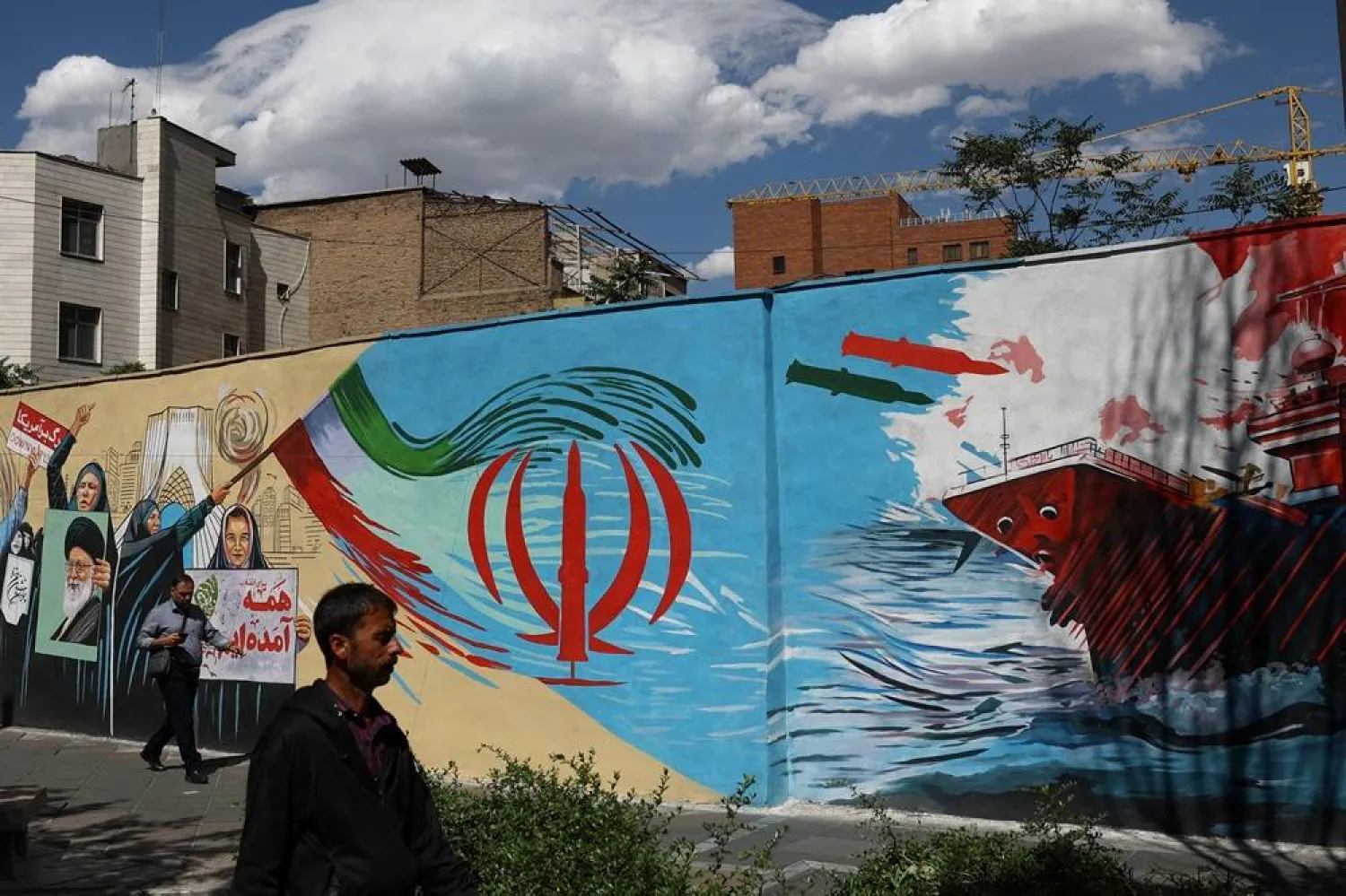 People walk on a street near a mural featuring an image of the late Supreme Leader of Iran, Ali Khamenei, in Tehran, Iran, May 18, 2026. Majid Asgaripour/WANA (West Asia News Agency) via Reuters